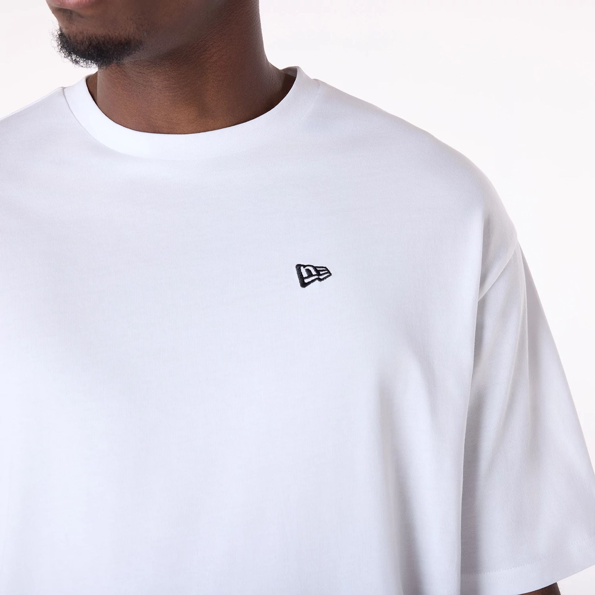 The Male model is wearing New Era Baseball Graphic White Oversized T-Shirt 7