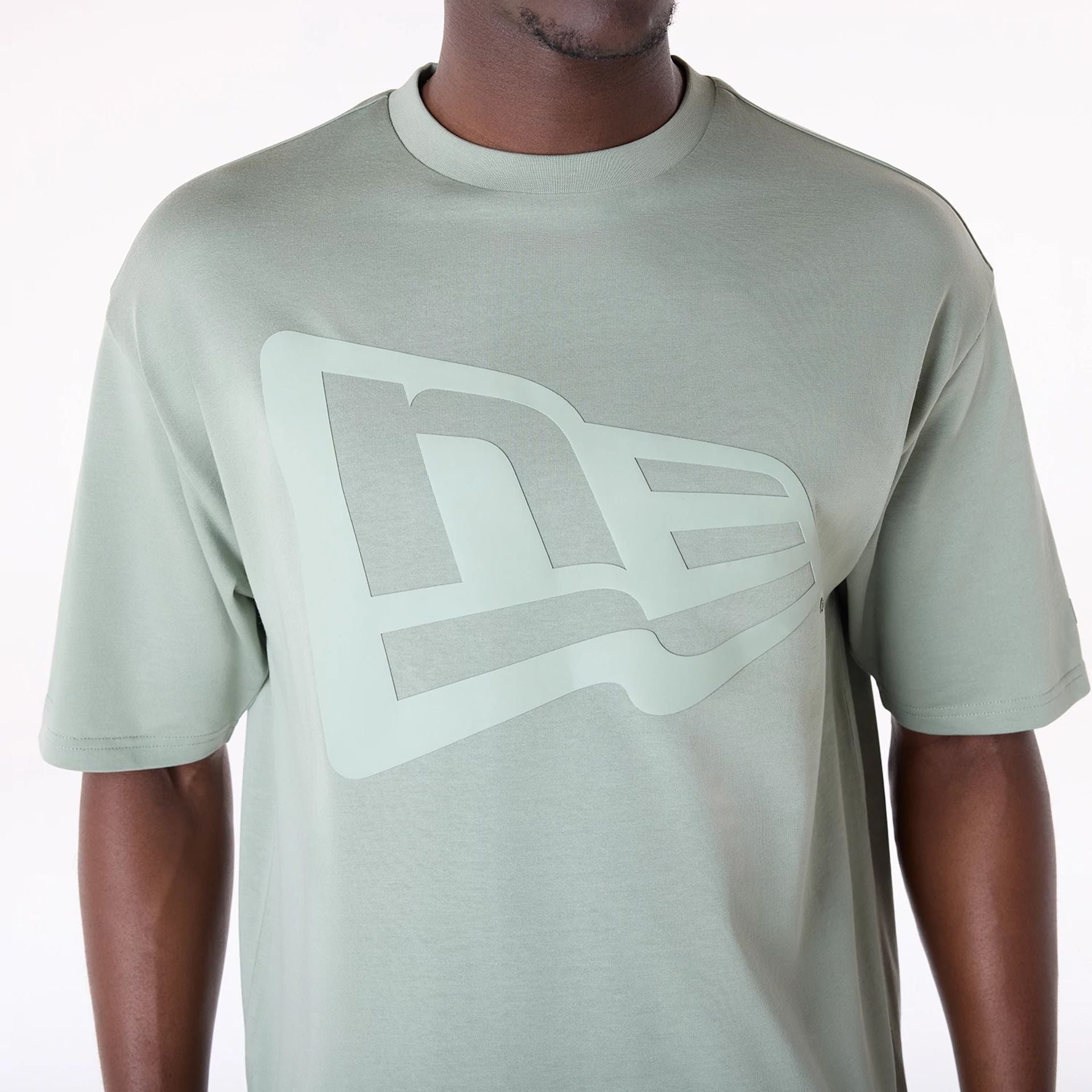 The Male model is wearing New Era Flag Pastel Green Oversized T-Shirt 3