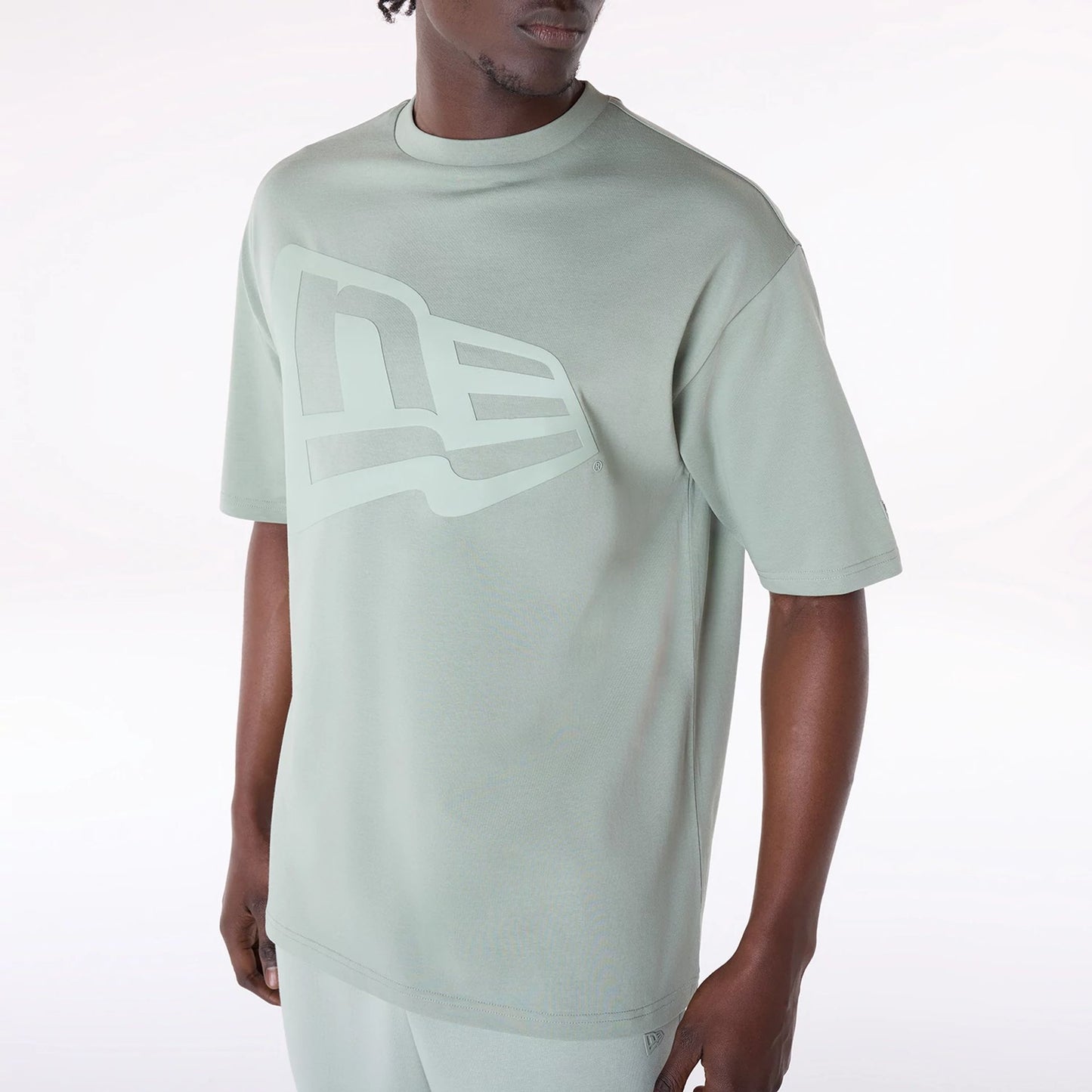 The Male model is wearing New Era Flag Pastel Green Oversized T-Shirt 7