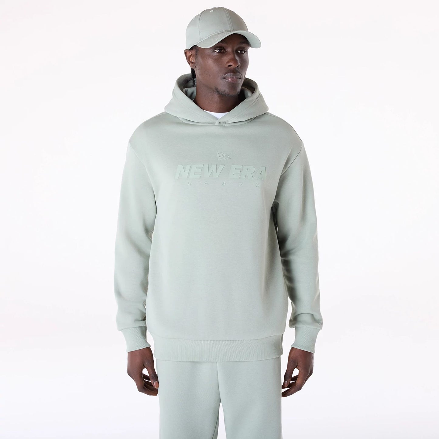 The Male model is wearing New Era Flag Pastel Green Oversized Pullover Hoodie 1