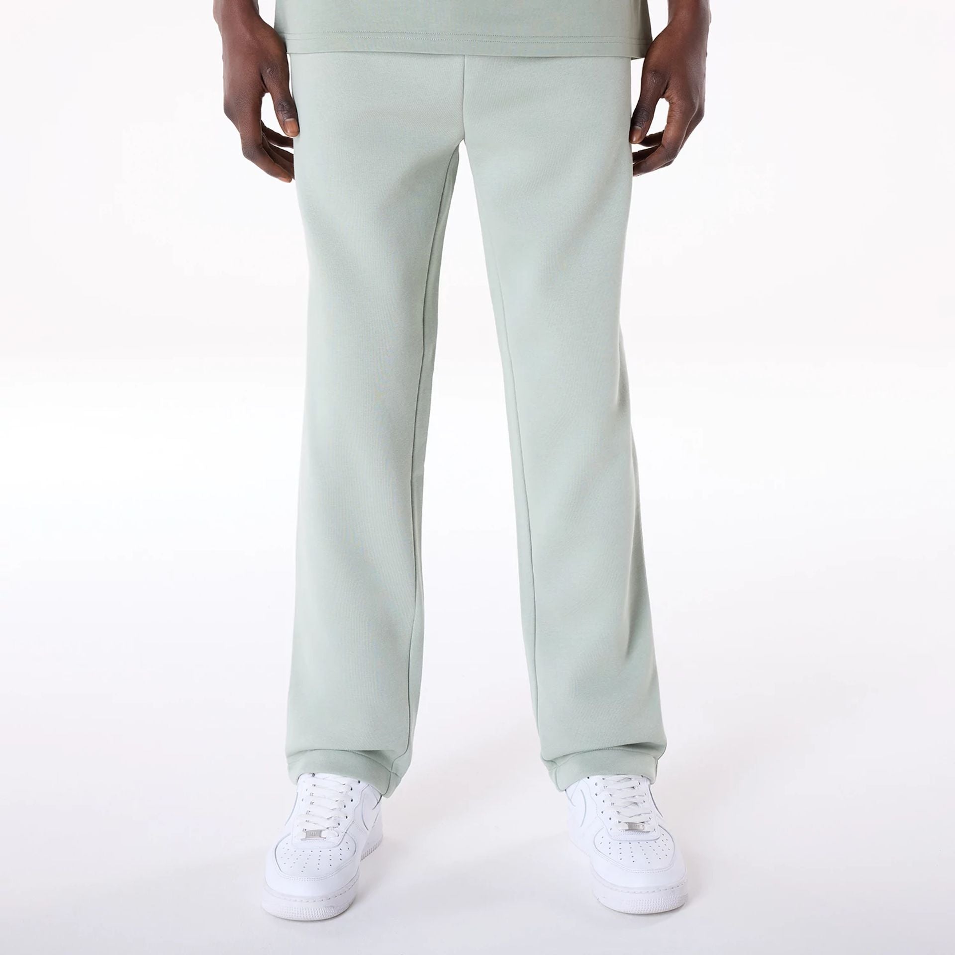 The Male model is wearing New Era Straight Leg Pastel Green Joggers 1