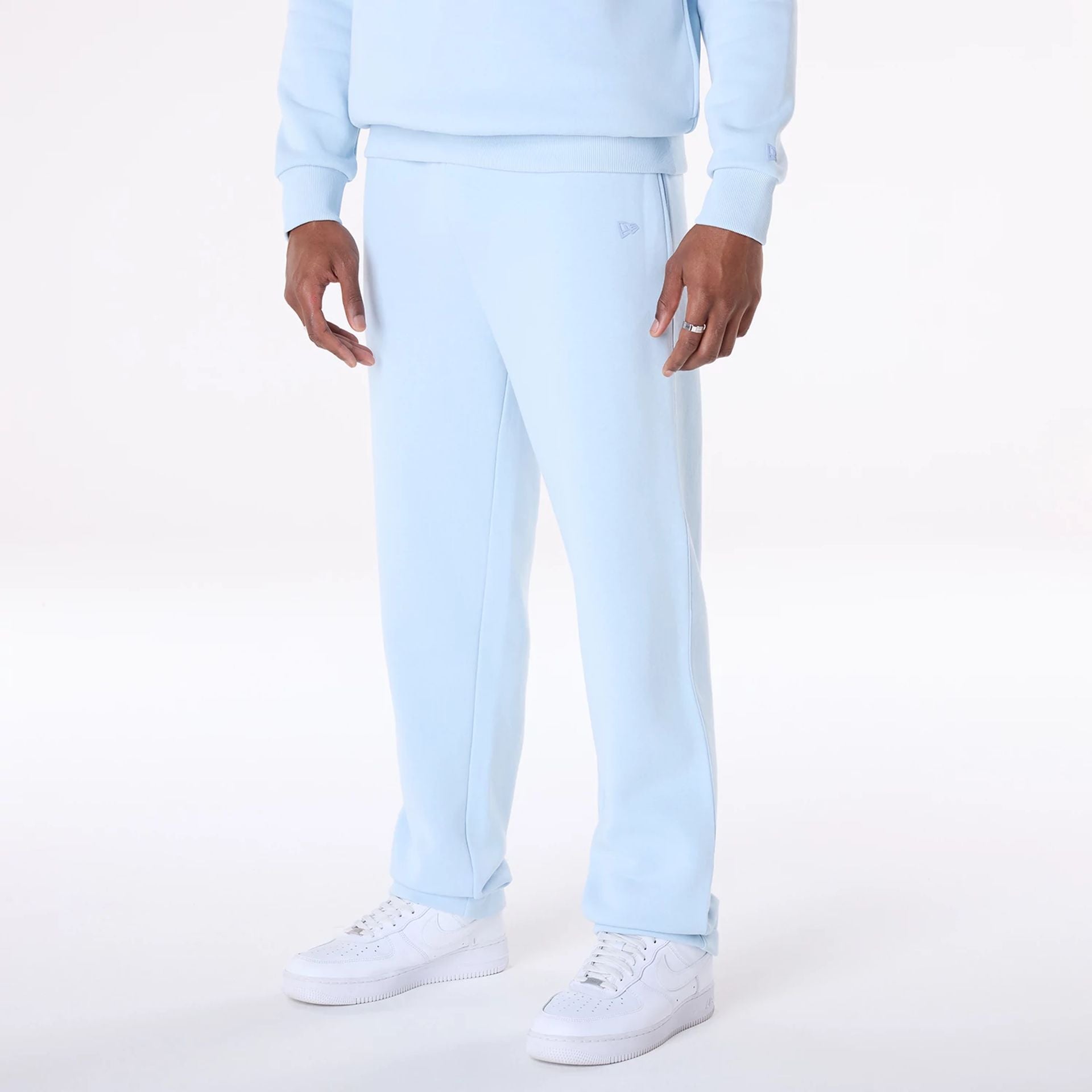 The Male model is wearing New Era Straight Leg Pastel Blue Joggers 2