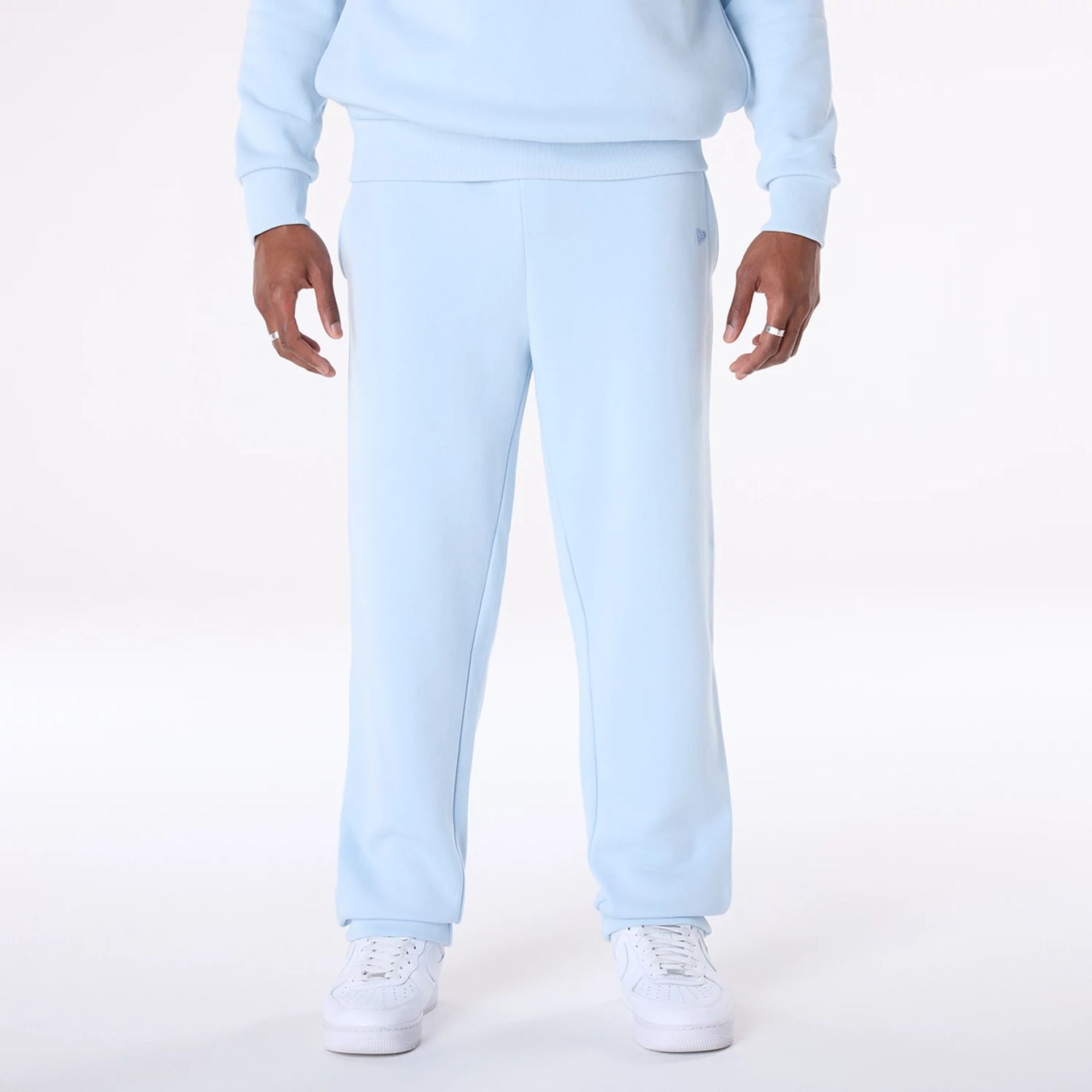 The Male model is wearing New Era Straight Leg Pastel Blue Joggers 1