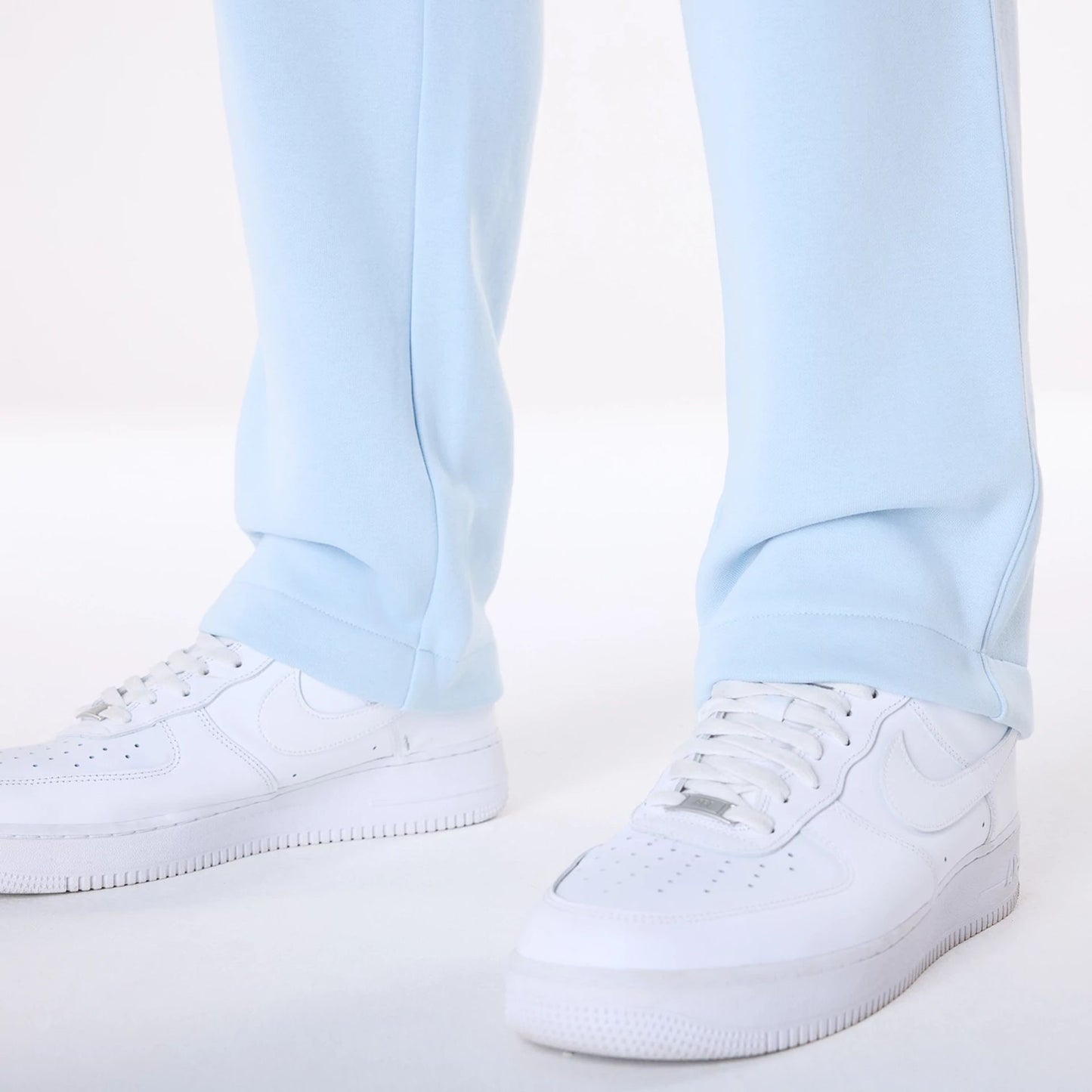 The Male model is wearing New Era Straight Leg Pastel Blue Joggers 3