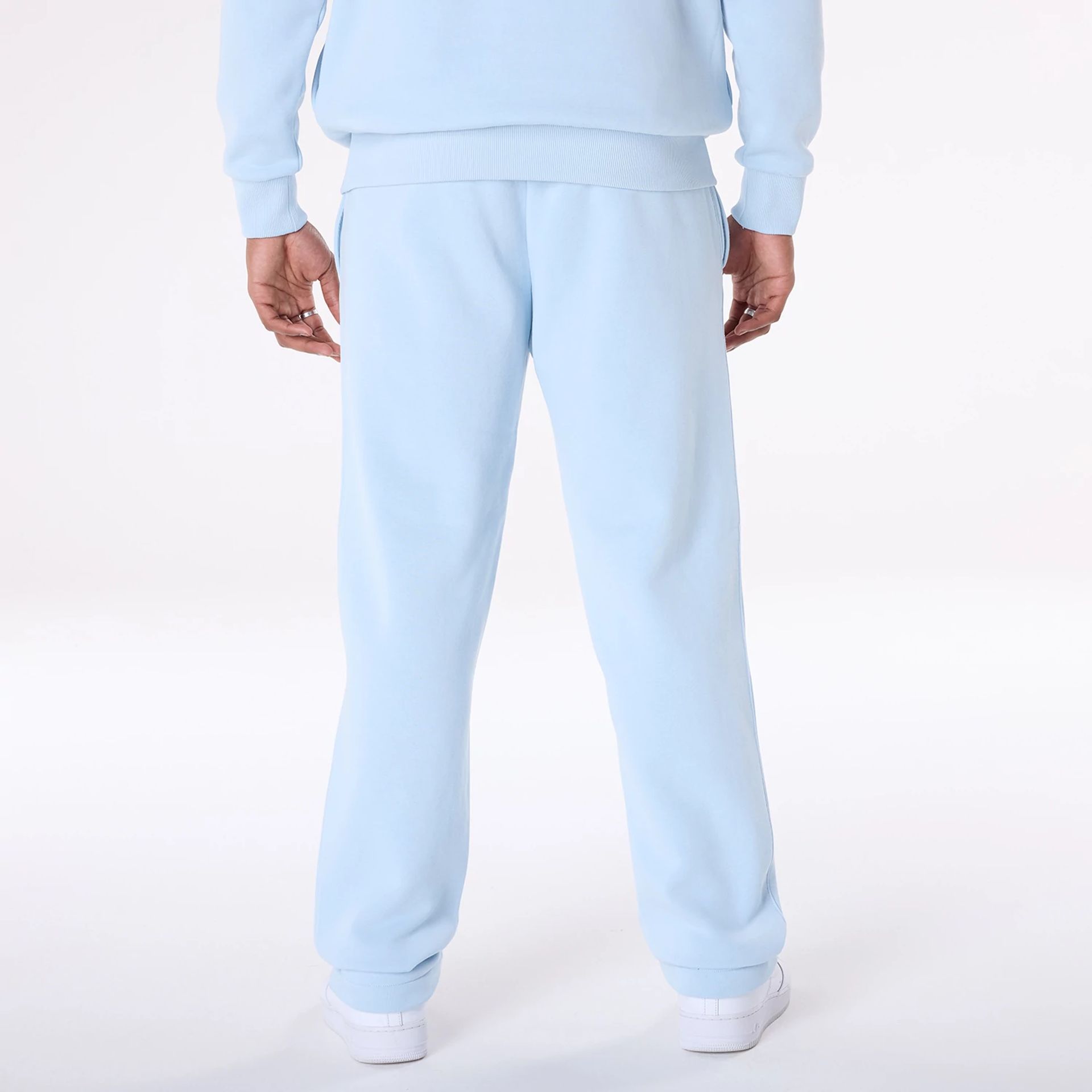 The Male model is wearing New Era Straight Leg Pastel Blue Joggers 8