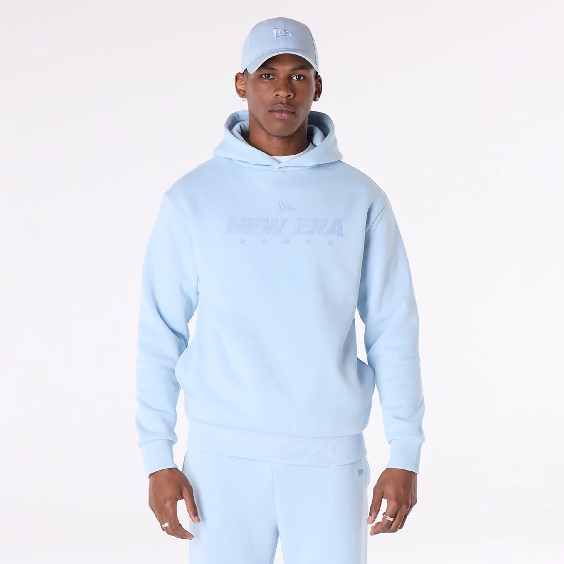 The Male model is wearing New Era Flag Pastel Blue Oversized Pullover Hoodie 4