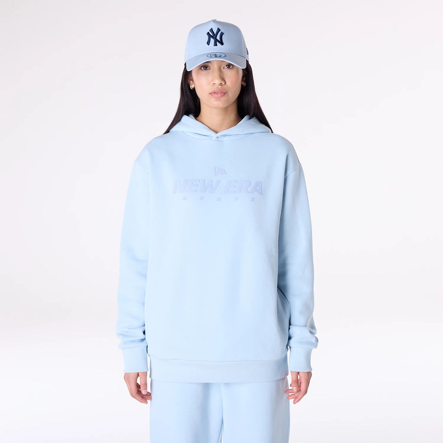 The Male model is wearing New Era Flag Pastel Blue Oversized Pullover Hoodie 6