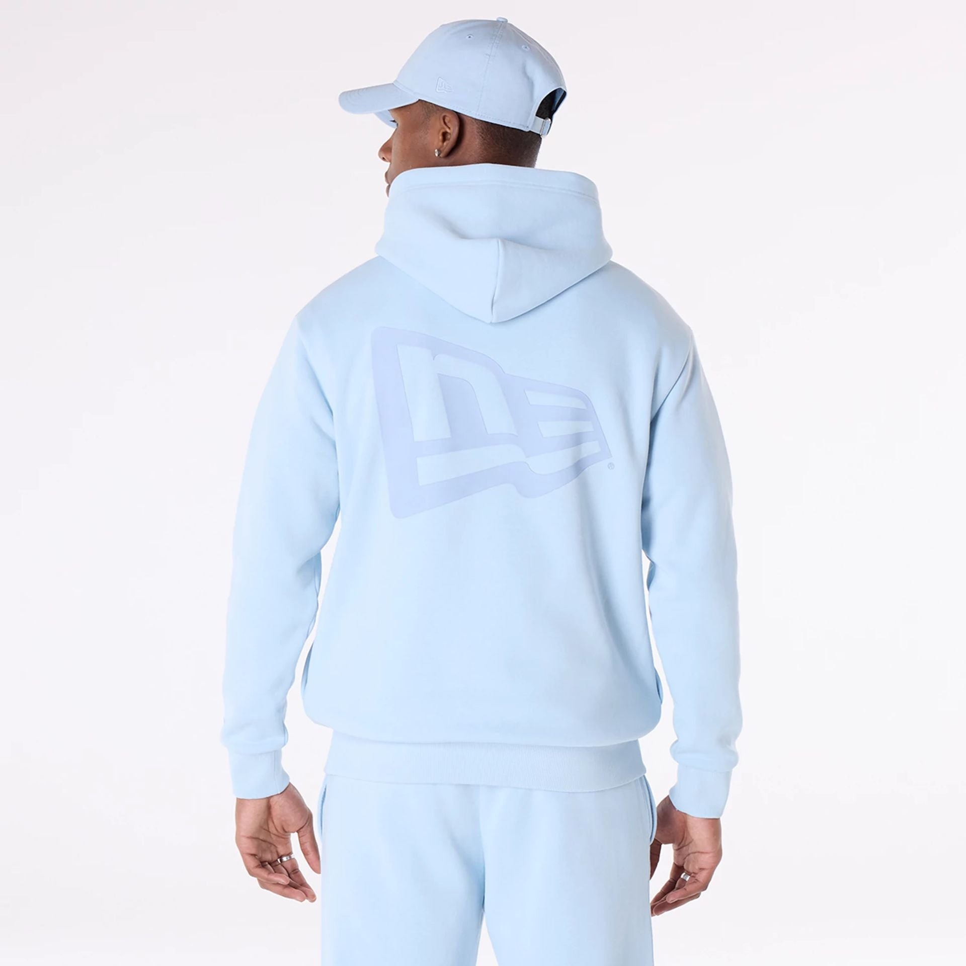 The Male model is wearing New Era Flag Pastel Blue Oversized Pullover Hoodie 2