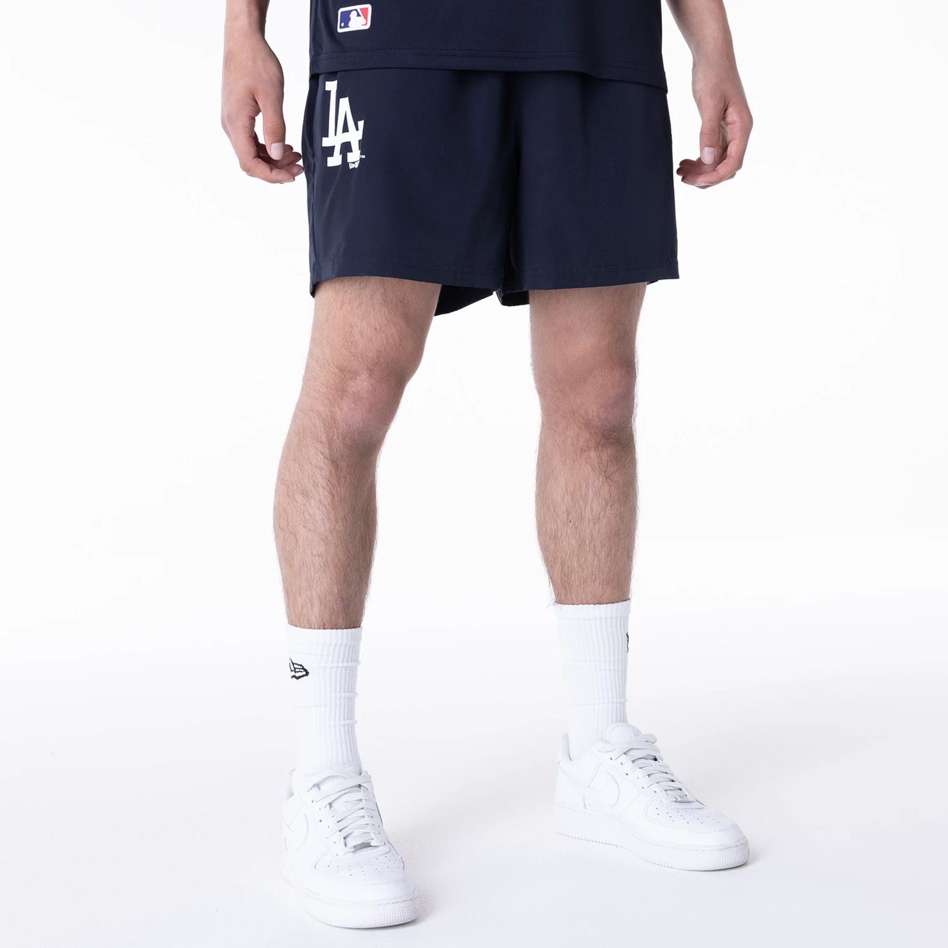 The Male model is wearing LA Dodgers League Essential Navy Shorts 1