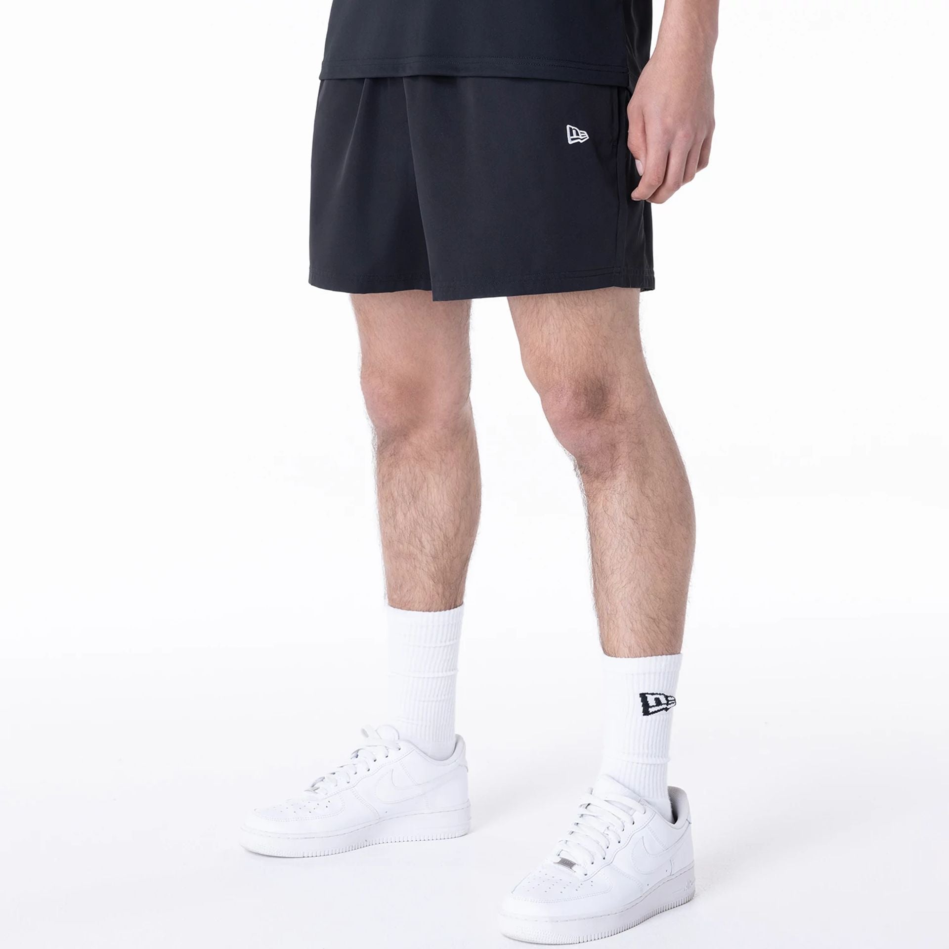 The Male model is wearing New York Yankees League Essential Black Shorts 8