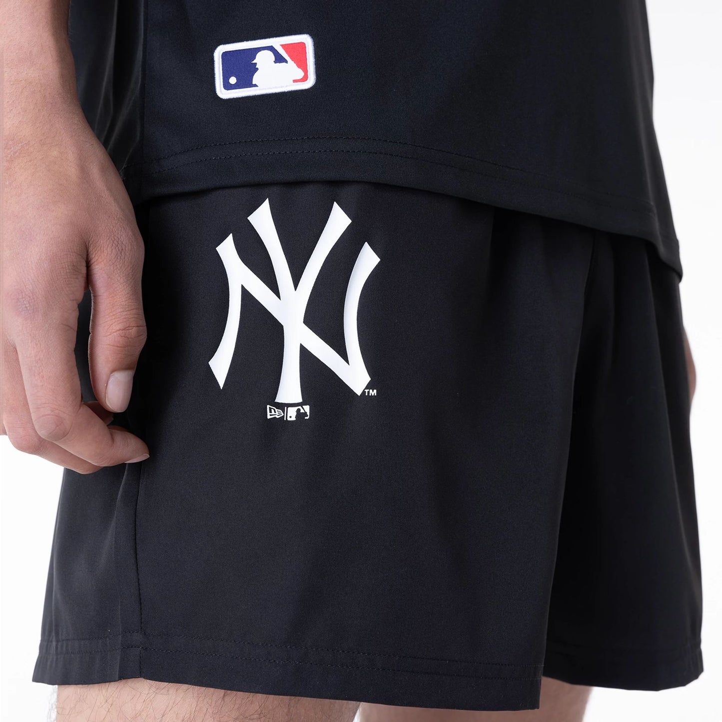 The Male model is wearing New York Yankees League Essential Black Shorts 7