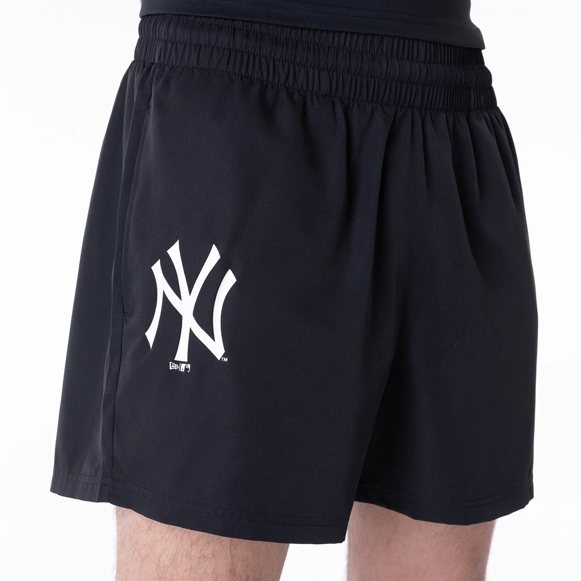 The Male model is wearing New York Yankees League Essential Black Shorts 2