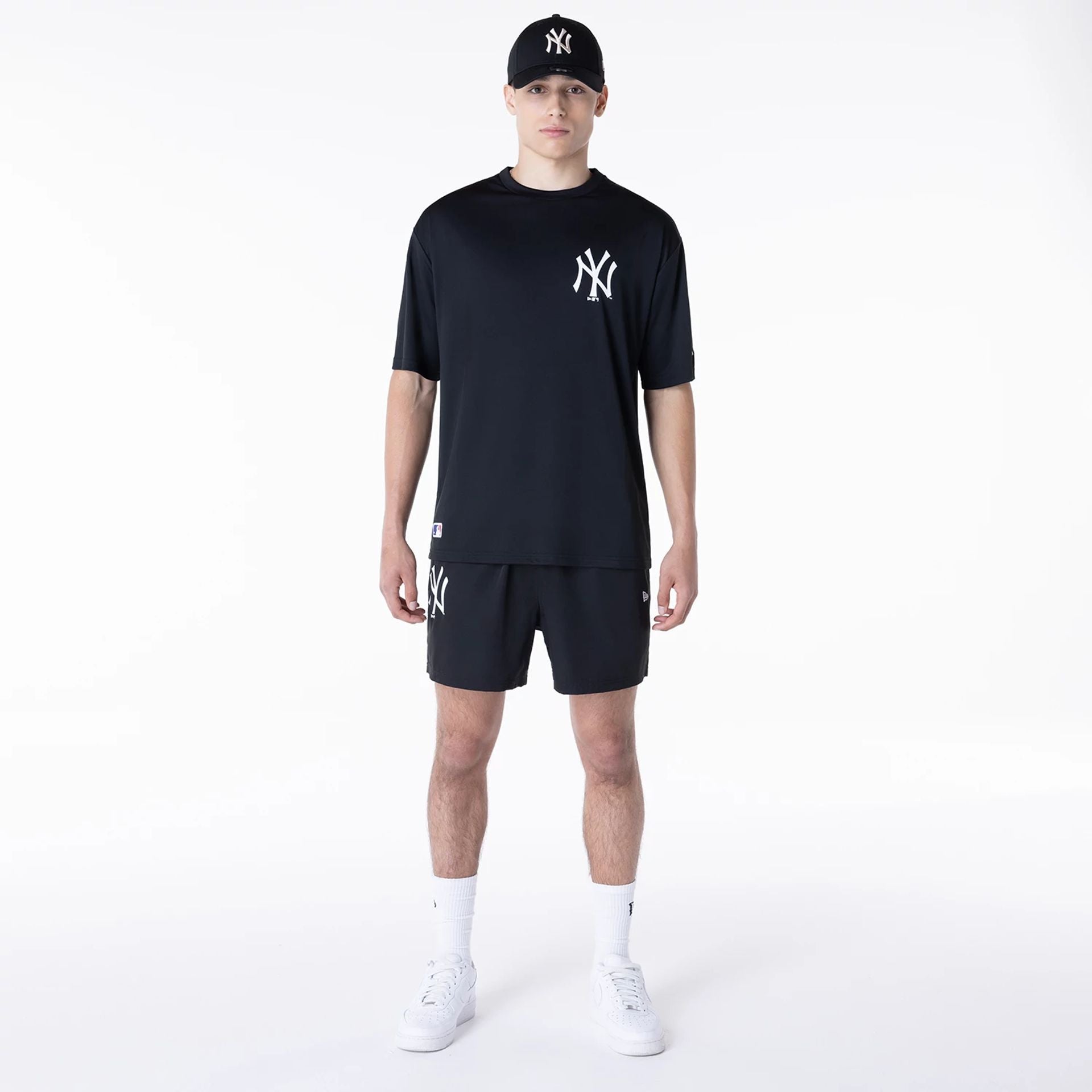 The Male model is wearing New York Yankees League Essential Black Shorts 4