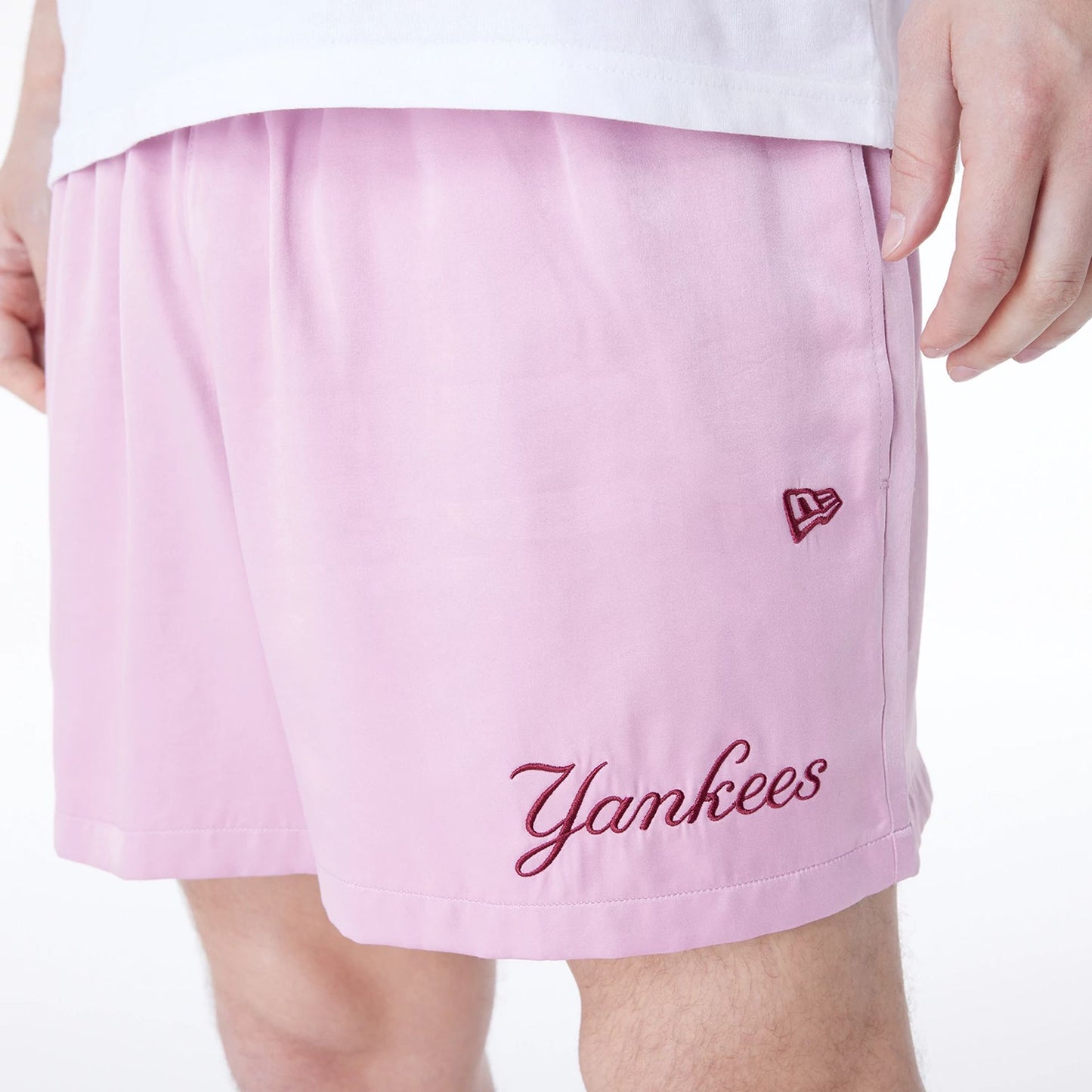 The Male model is wearing New York Yankees MLB Woven Dark Pink Shorts 2