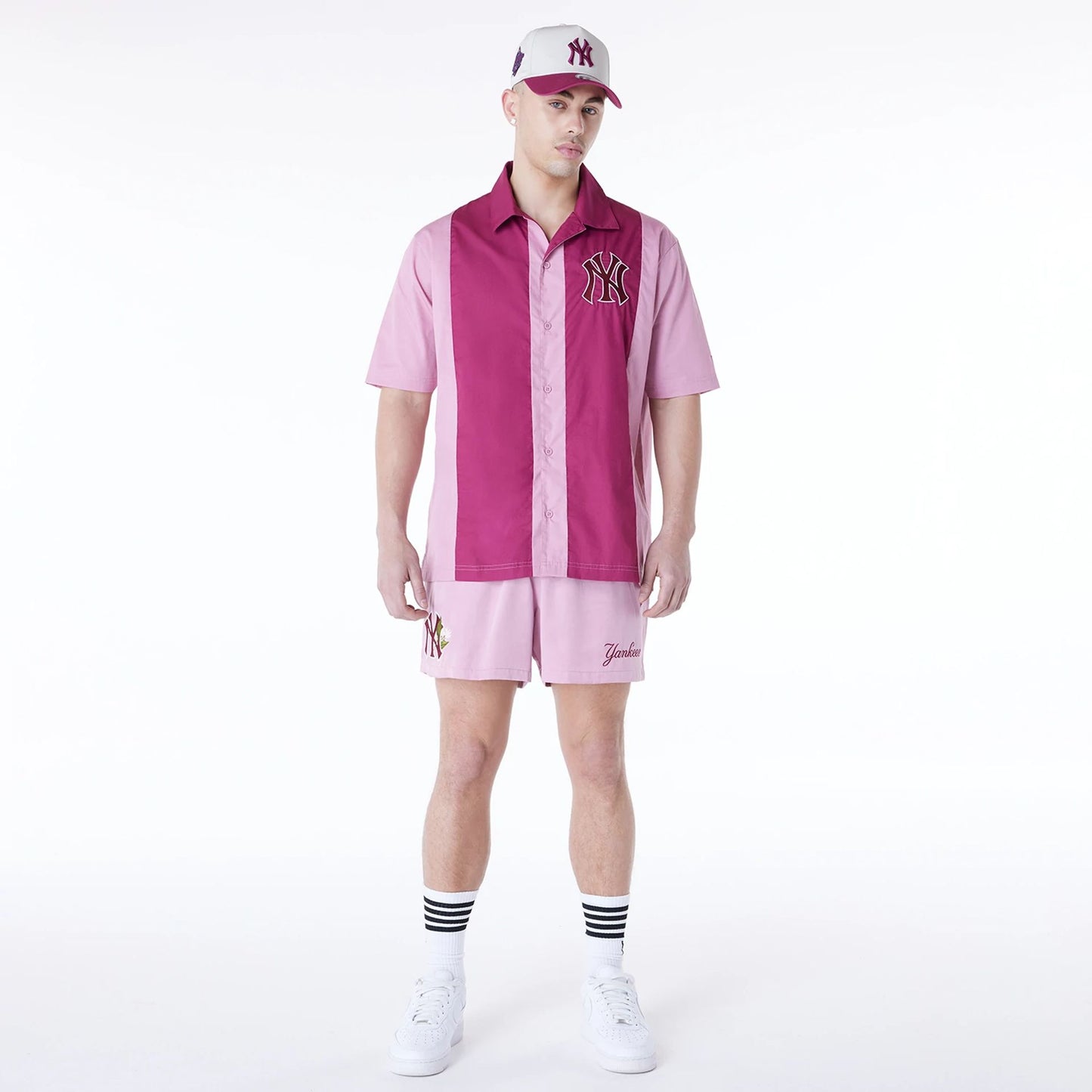 The Male model is wearing New York Yankees MLB Woven Dark Pink Shorts 5