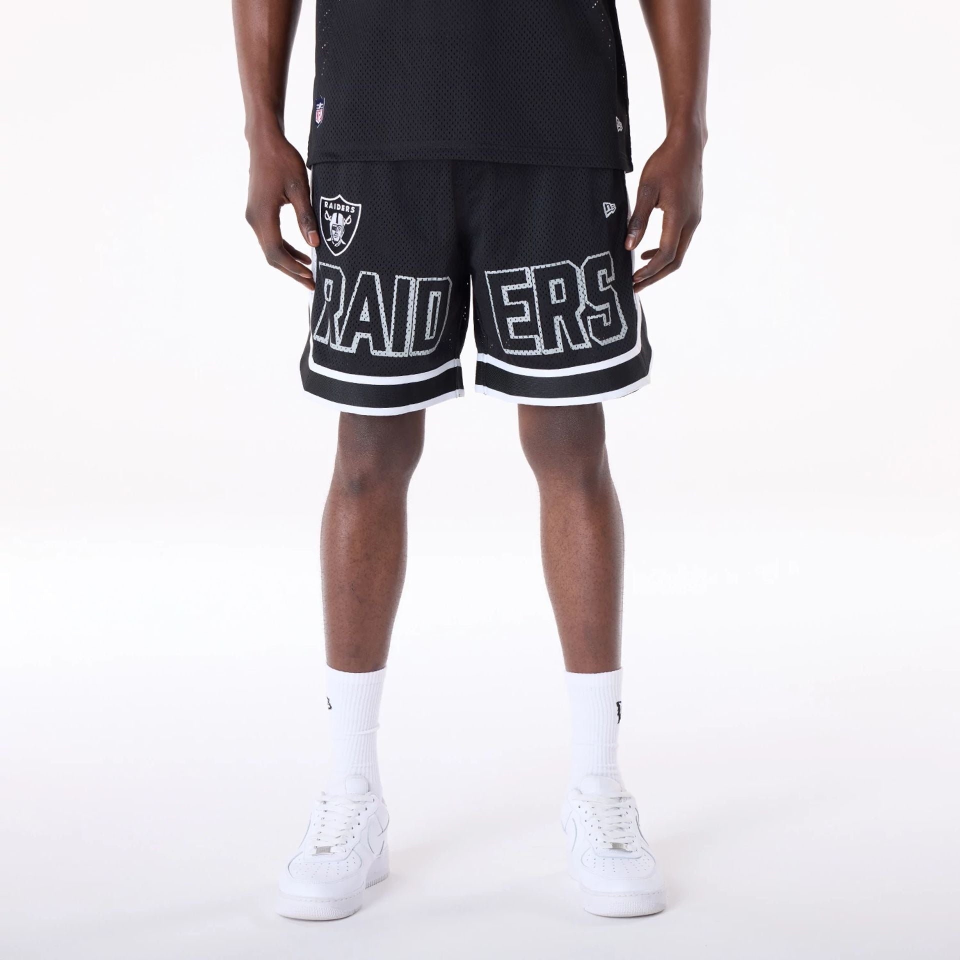 The Male model is wearing Las Vegas Raiders NFL Mesh Black Shorts 1