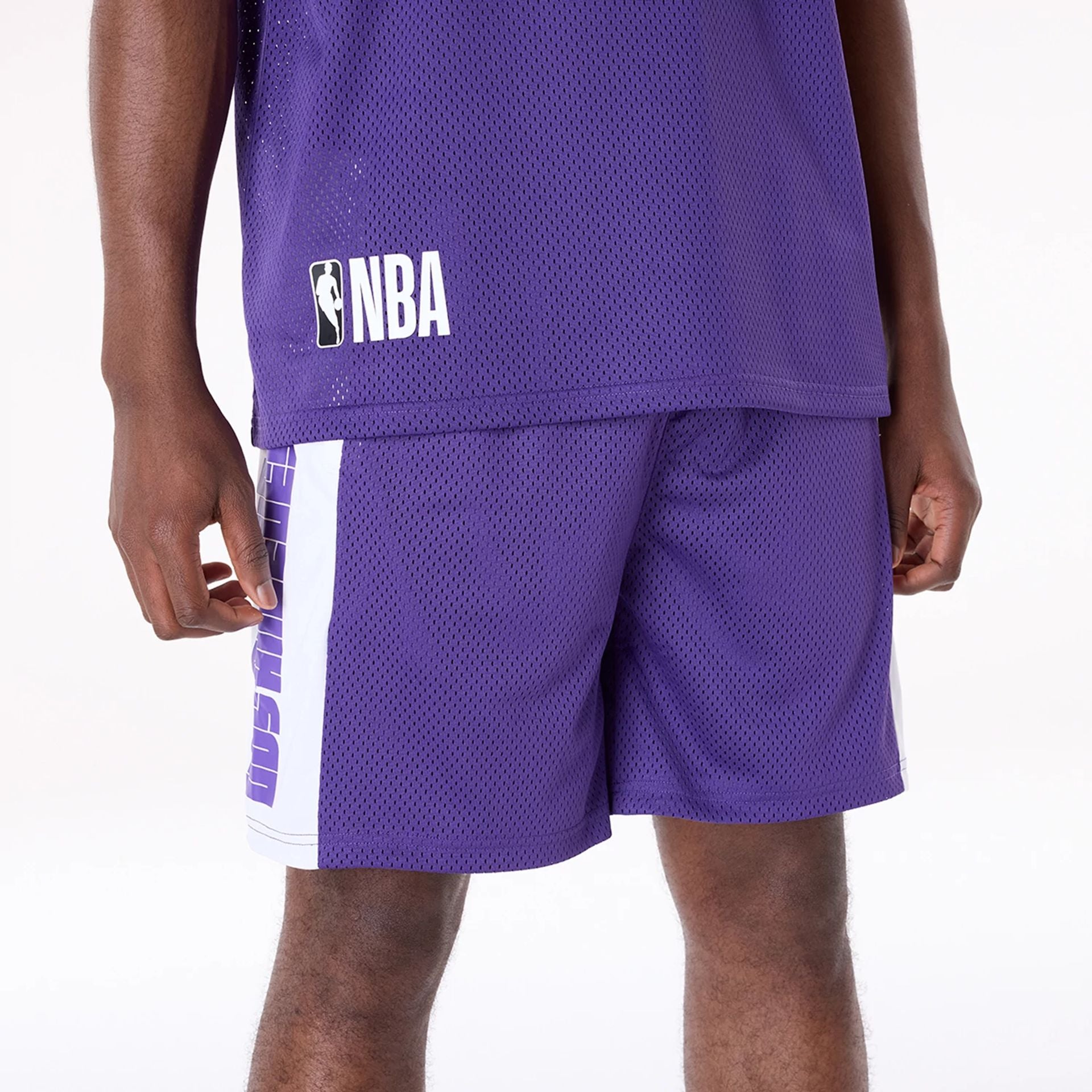 The Male model is wearing LA Lakers NBA Graphic Purple Mesh Shorts 2