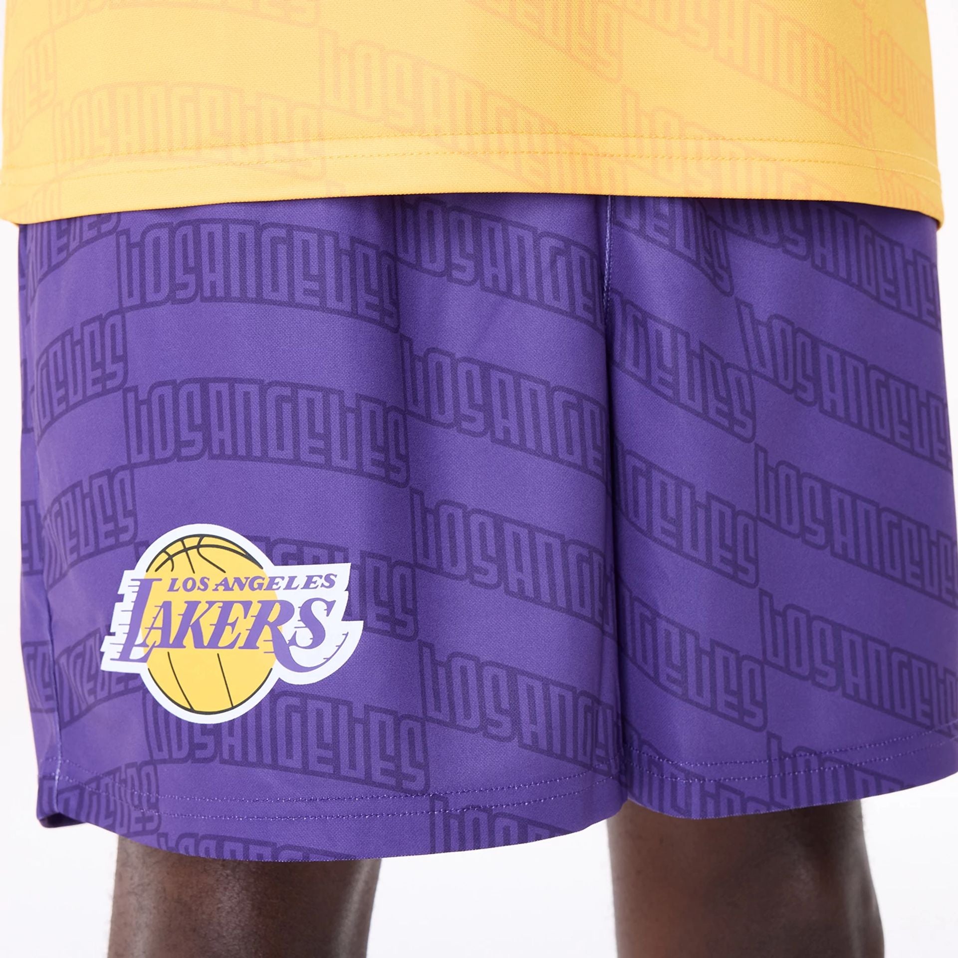 The Male model is wearing LA Lakers NBA All Over Print Graphic Purple Shorts 5