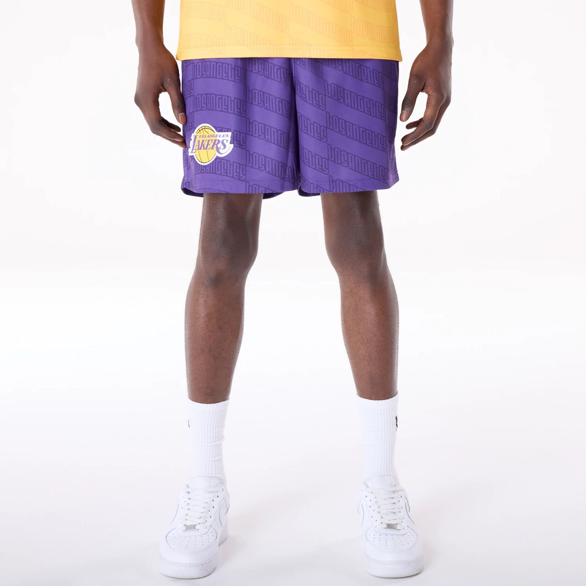 The Male model is wearing LA Lakers NBA All Over Print Graphic Purple Shorts 1