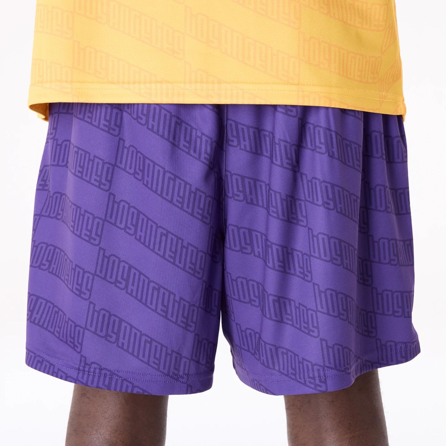 The Male model is wearing LA Lakers NBA All Over Print Graphic Purple Shorts 3