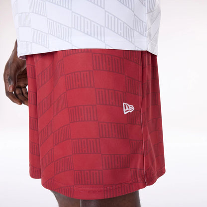 The Male model is wearing Miami Heat NBA All Over Print Graphic Dark Red Shorts 7