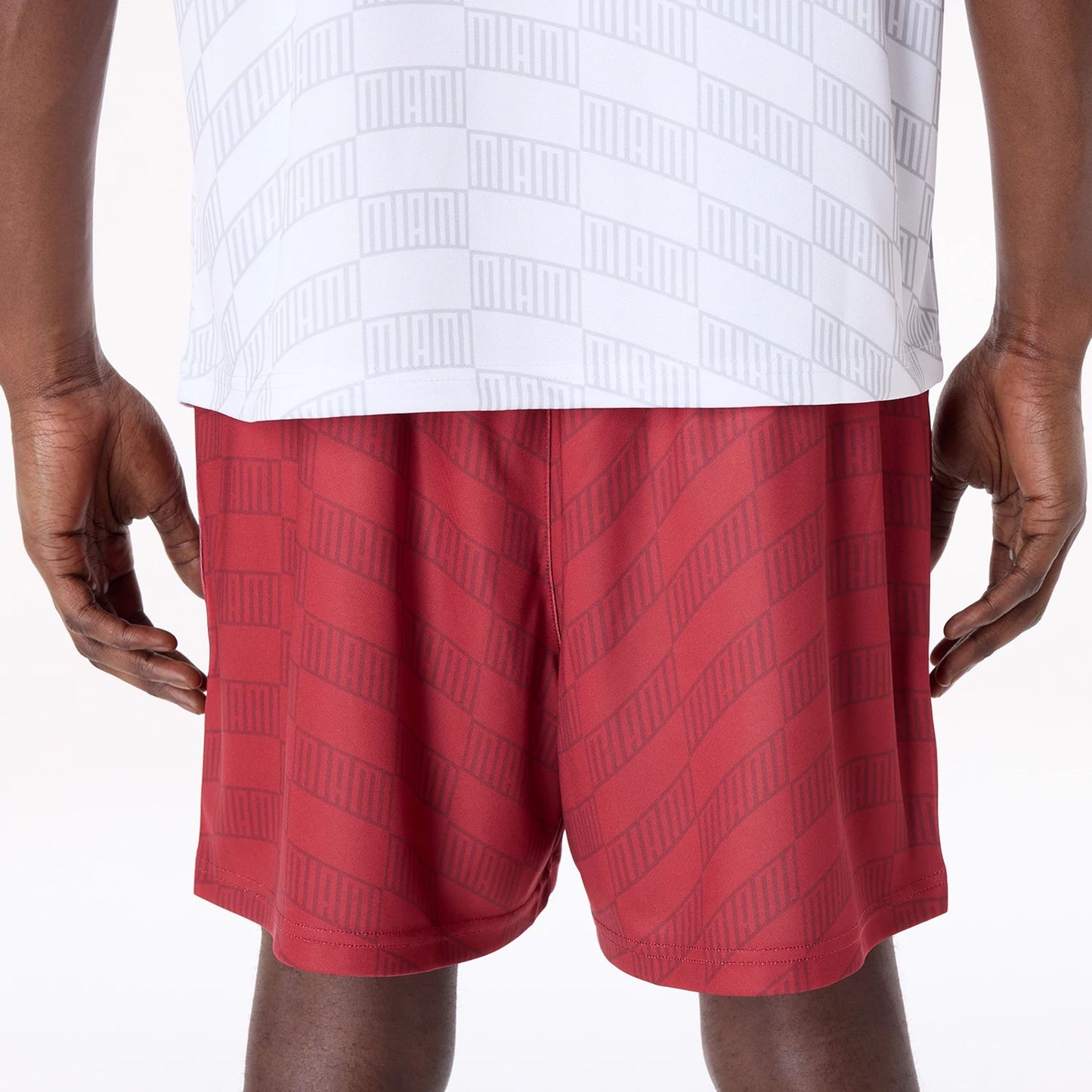 The Male model is wearing Miami Heat NBA All Over Print Graphic Dark Red Shorts 5