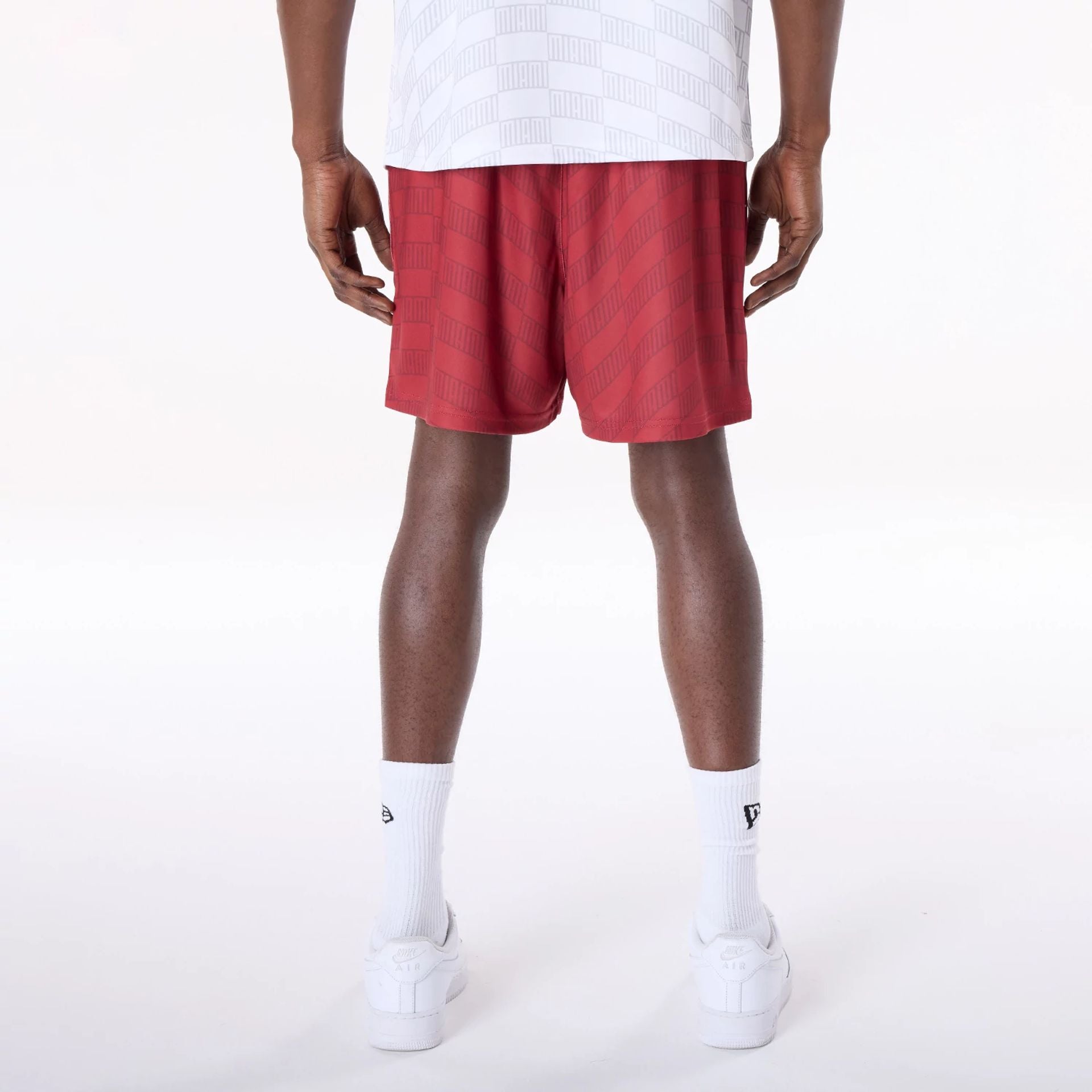 The Male model is wearing Miami Heat NBA All Over Print Graphic Dark Red Shorts 2