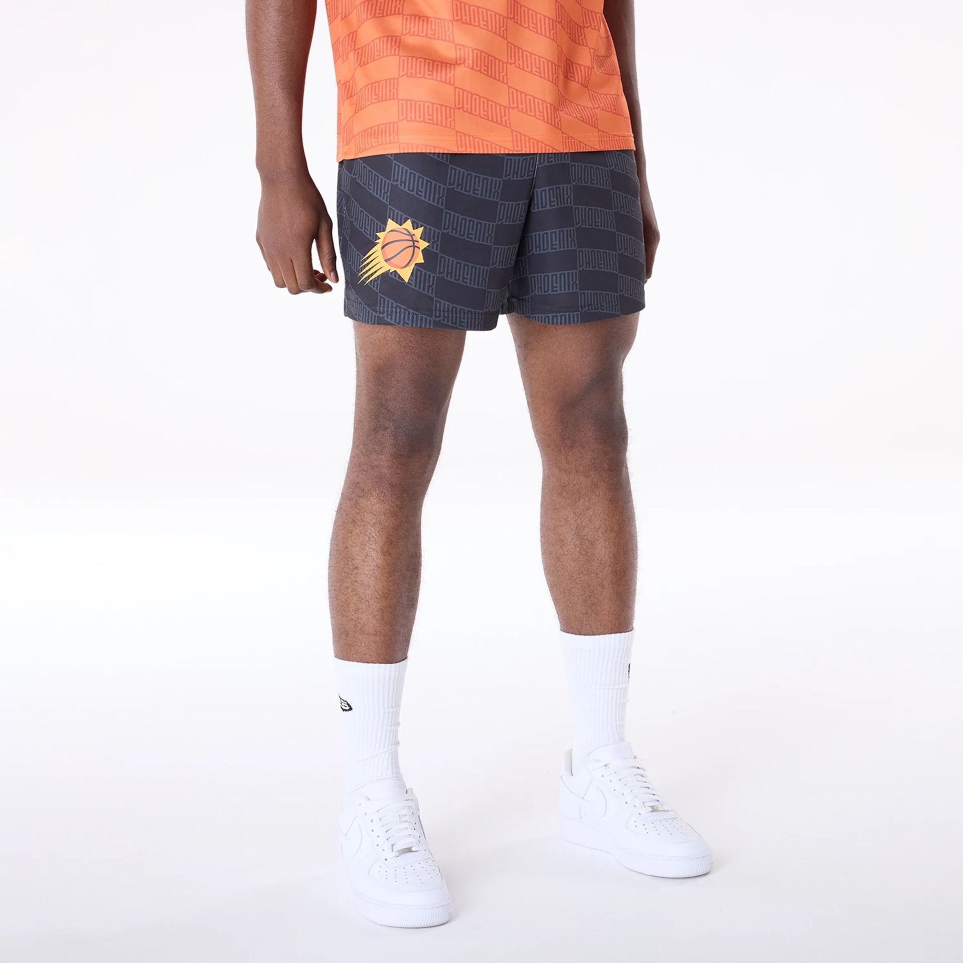 The Male model is wearing Phoenix Suns NBA All Over Print Graphic Black Shorts 1