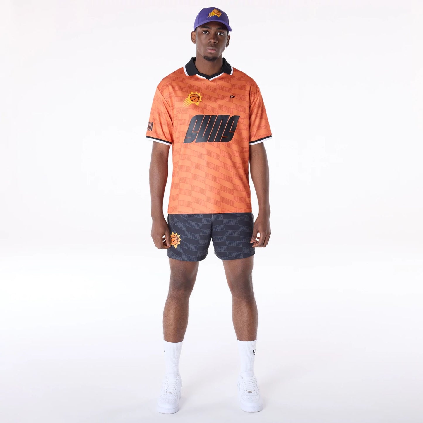 The Male model is wearing Phoenix Suns NBA All Over Print Graphic Black Shorts 5