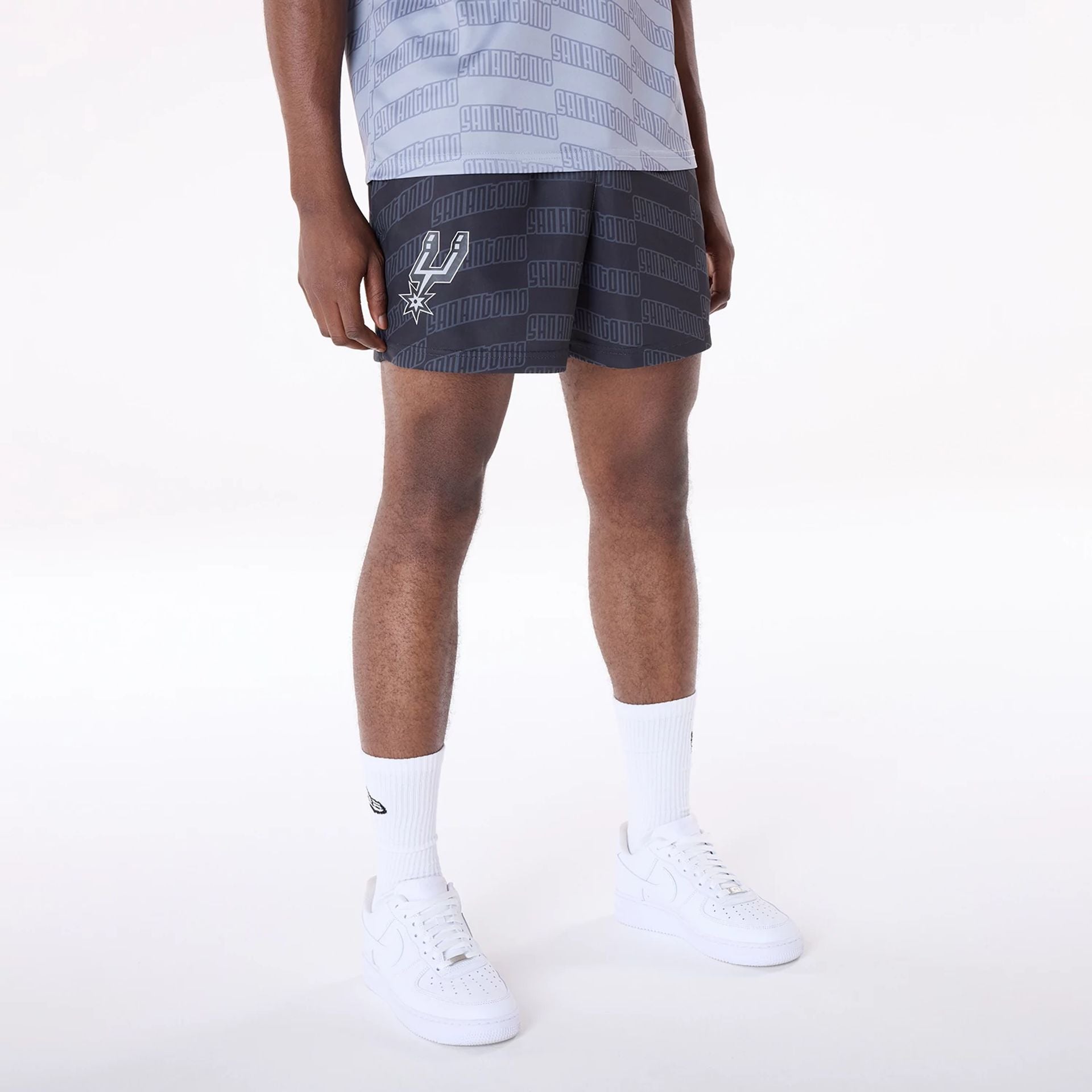 The Male model is wearing San Antonio Spurs NBA All Over Print Graphic Black Shorts 1