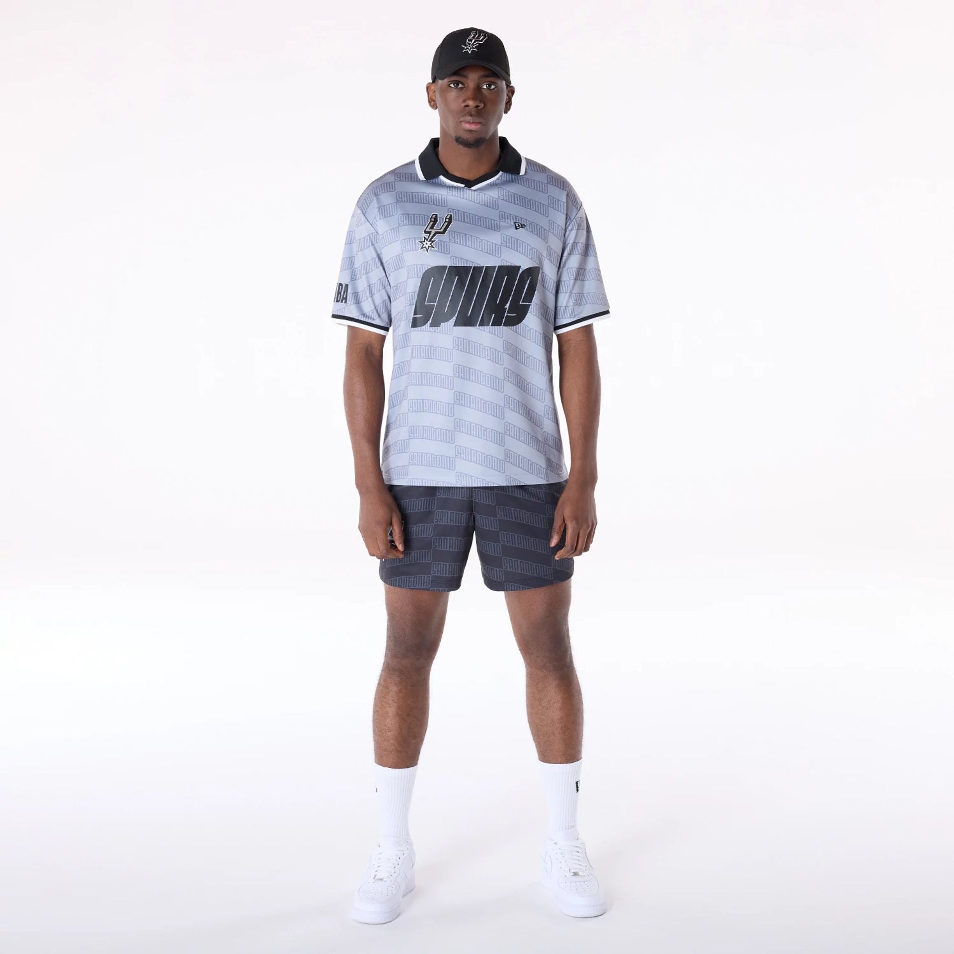 The Male model is wearing San Antonio Spurs NBA All Over Print Graphic Black Shorts 4