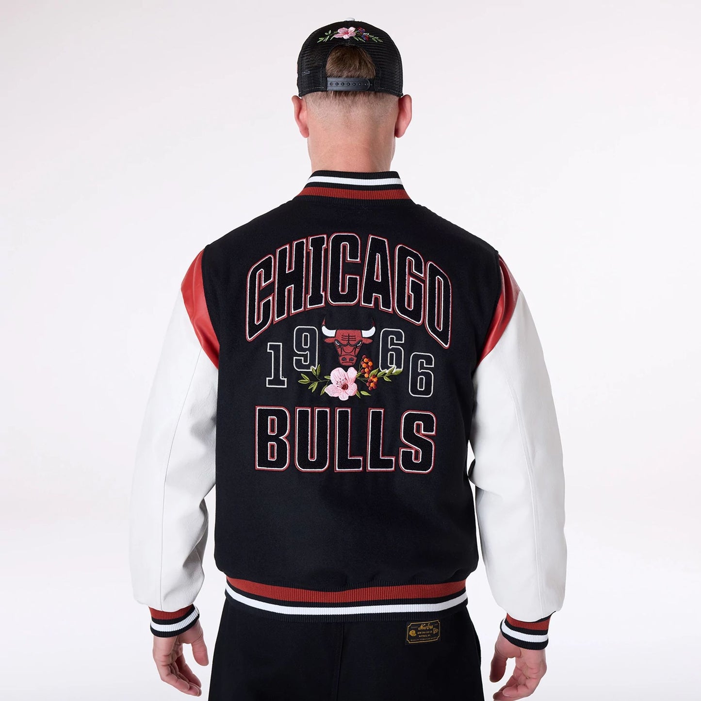 The Male model is wearing Chicago Bulls NBA Floral Black Varsity Jacket 2