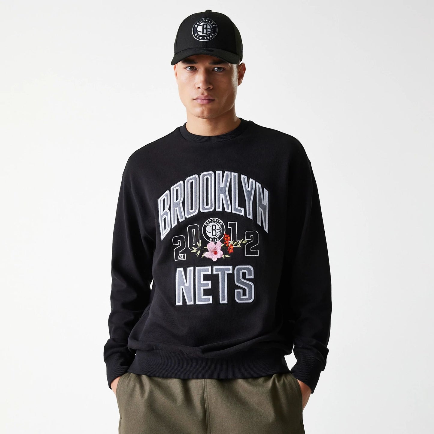 The Male model is wearing Brooklyn Nets NBA Floral Black Oversized Crew Neck Sweater 1