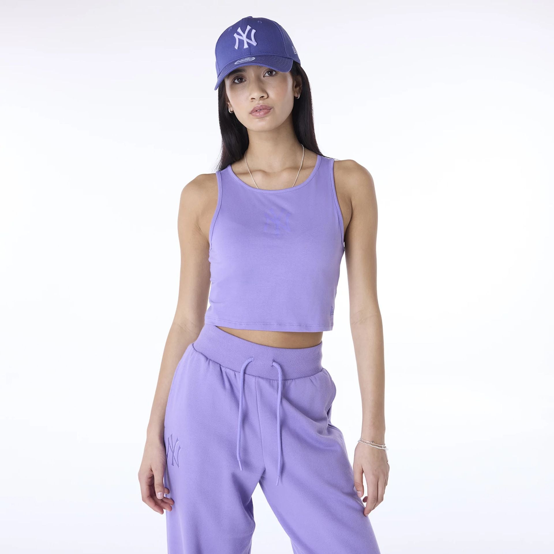 The Female model is wearing New York Yankees Womens MLB League Essential Purple Vest 1