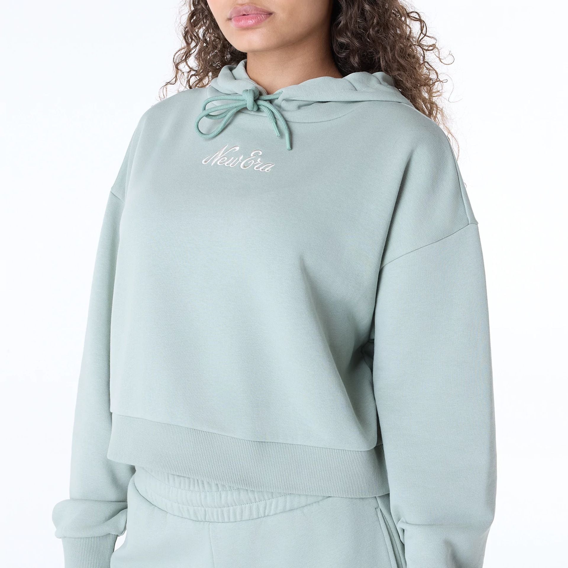 The Female model is wearing Womens New Era Script Pastel Green Pullover Hoodie 2