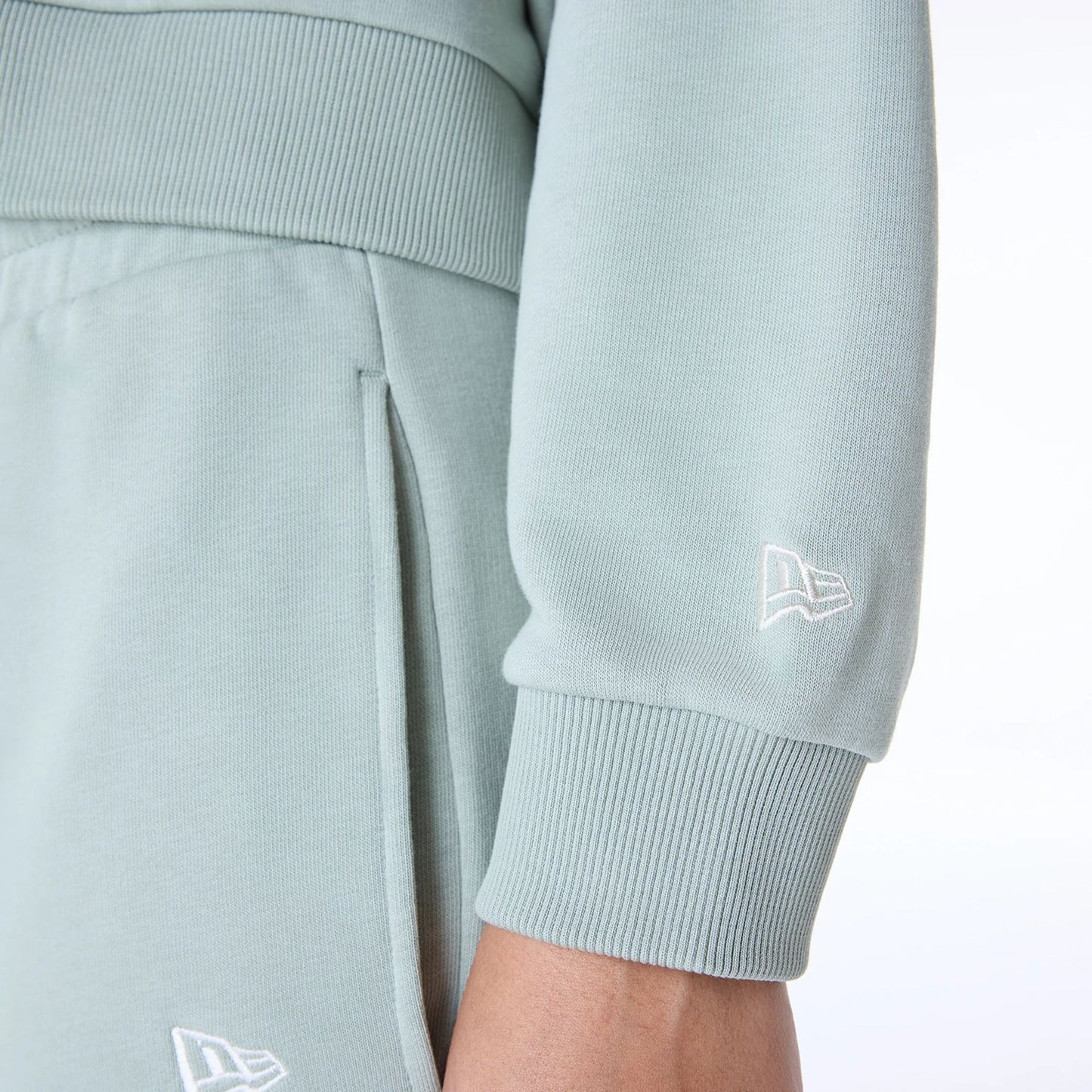 The Female model is wearing Womens New Era Script Pastel Green Pullover Hoodie 4