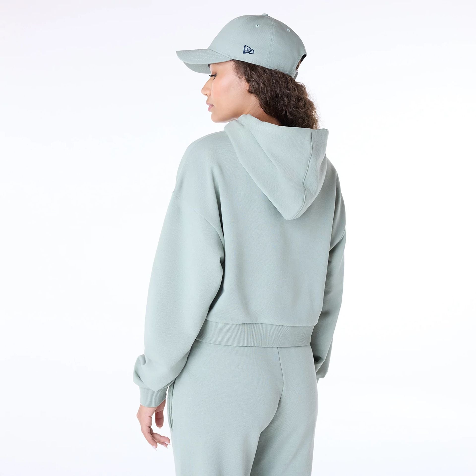 The Female model is wearing Womens New Era Script Pastel Green Pullover Hoodie 7