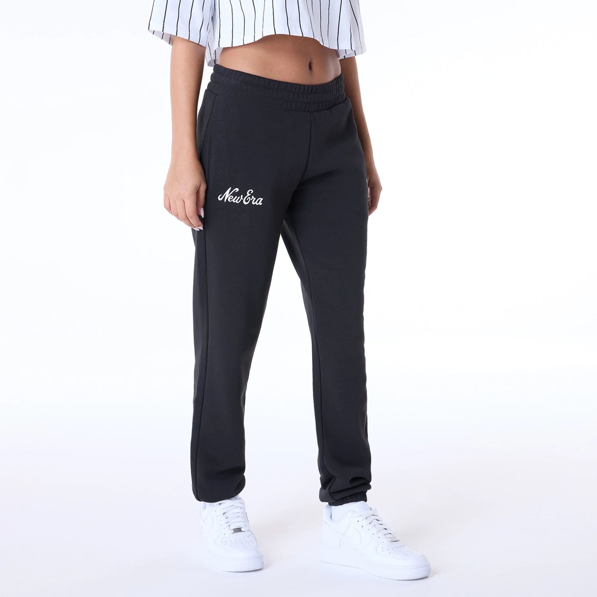 The Female model is wearing Womens New Era Script Black Joggers 1