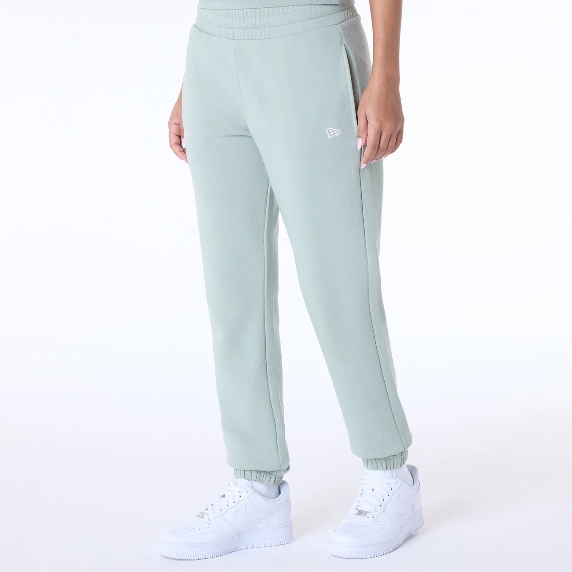 The Female model is wearing Womens New Era Script Pastel Green Joggers 2