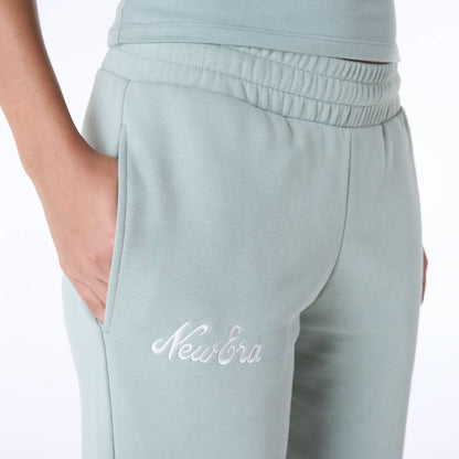 The Female model is wearing Womens New Era Script Pastel Green Joggers 3