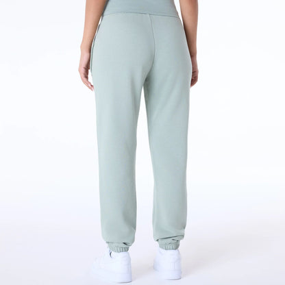 The Female model is wearing Womens New Era Script Pastel Green Joggers 7