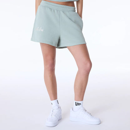 The Female model is wearing Womens New Era Script Pastel Green Shorts 1