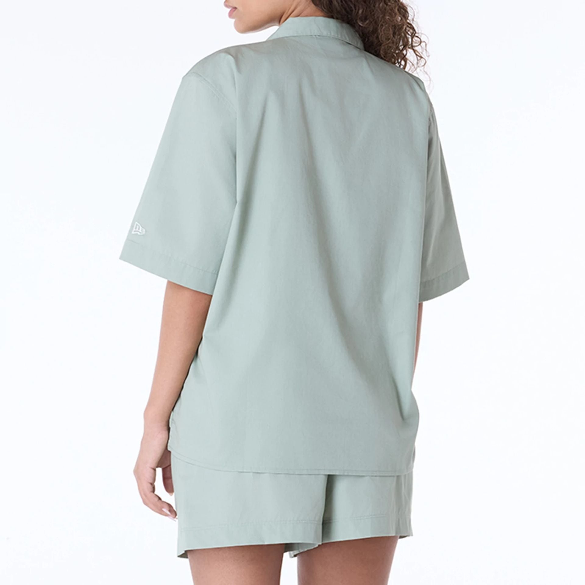 The Female model is wearing Womens New Era Revere Pastel Green T-Shirt 7