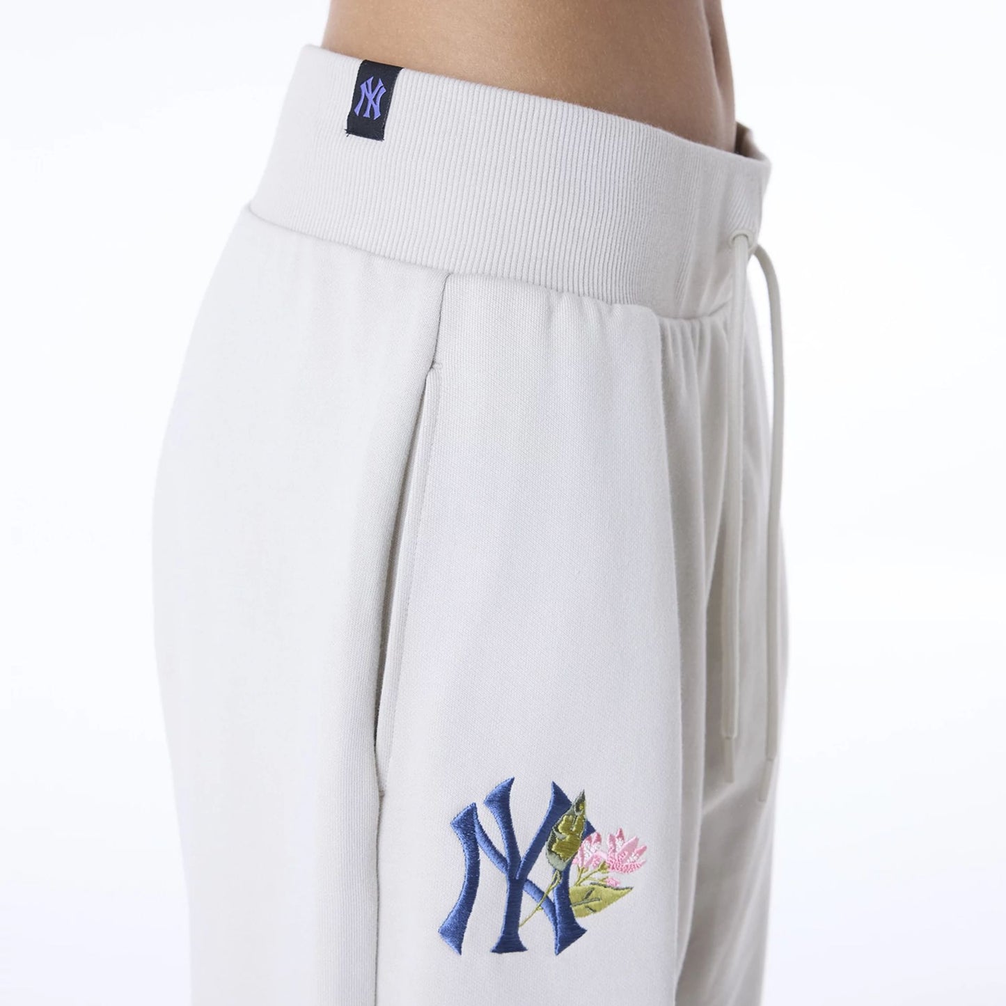 The Female model is wearing New York Yankees Womens MLB Floral Light Beige Joggers 5