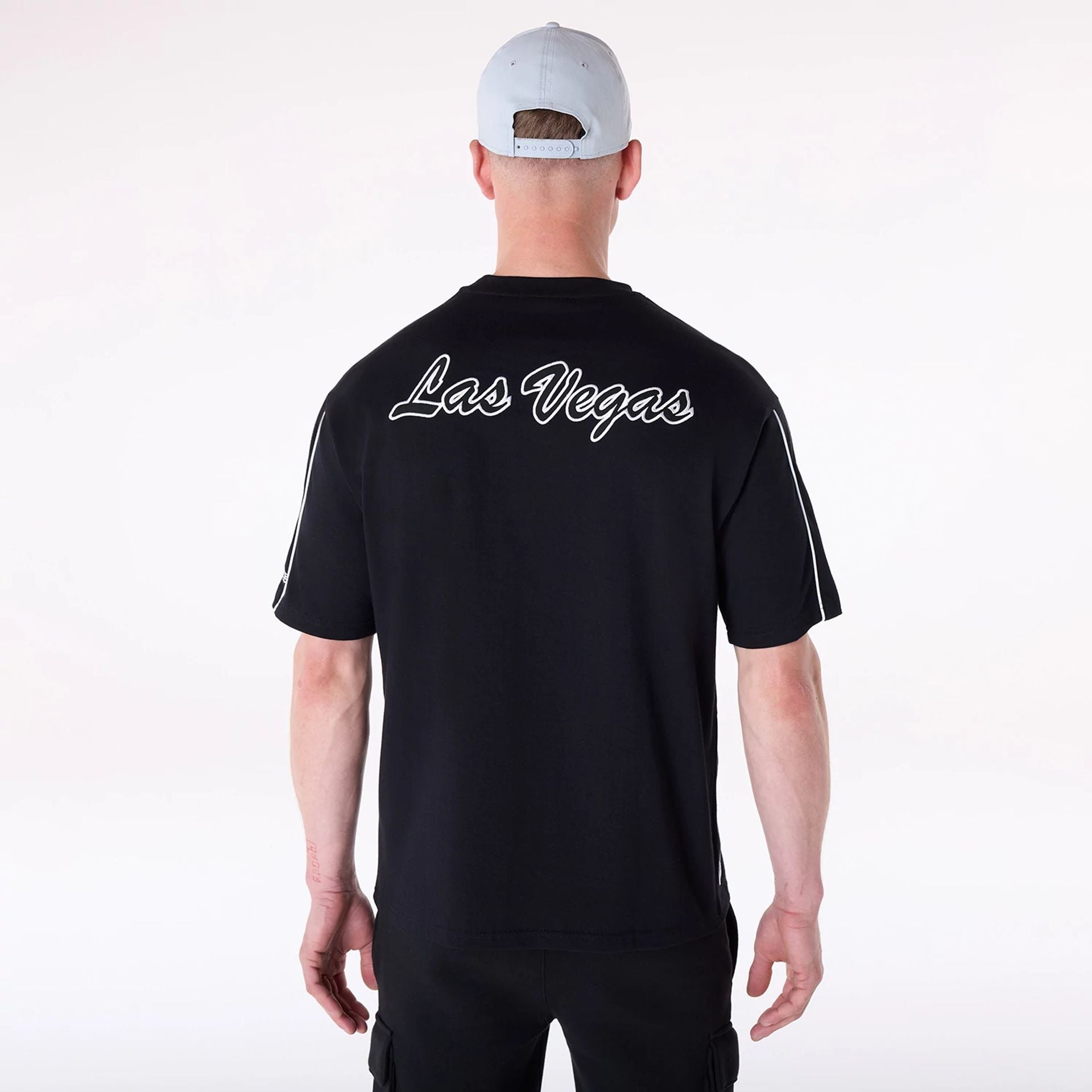 The Male model is wearing Las Vegas Raiders NFL Heritage Black Oversized T-Shirt 2