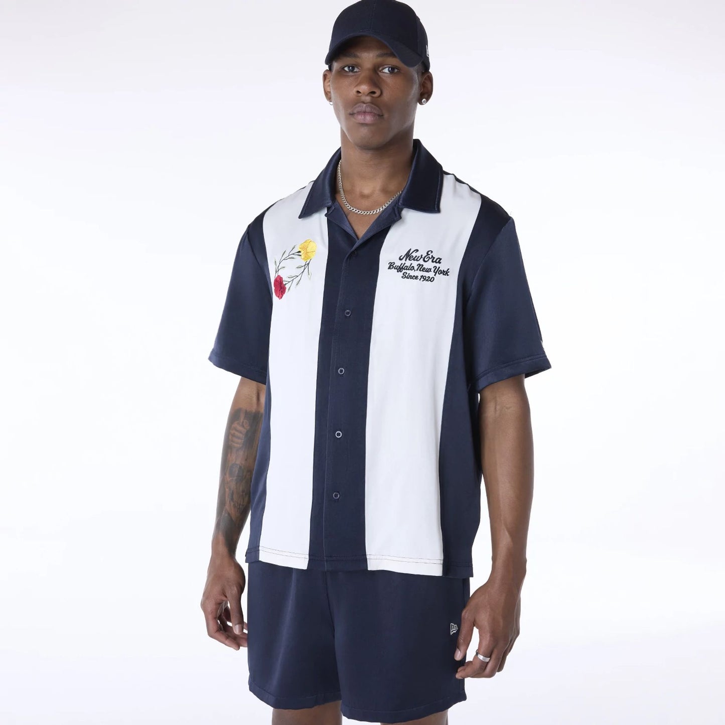 The Male model is wearing New Era Stripe Revere Navy Short Sleeve Shirt 1