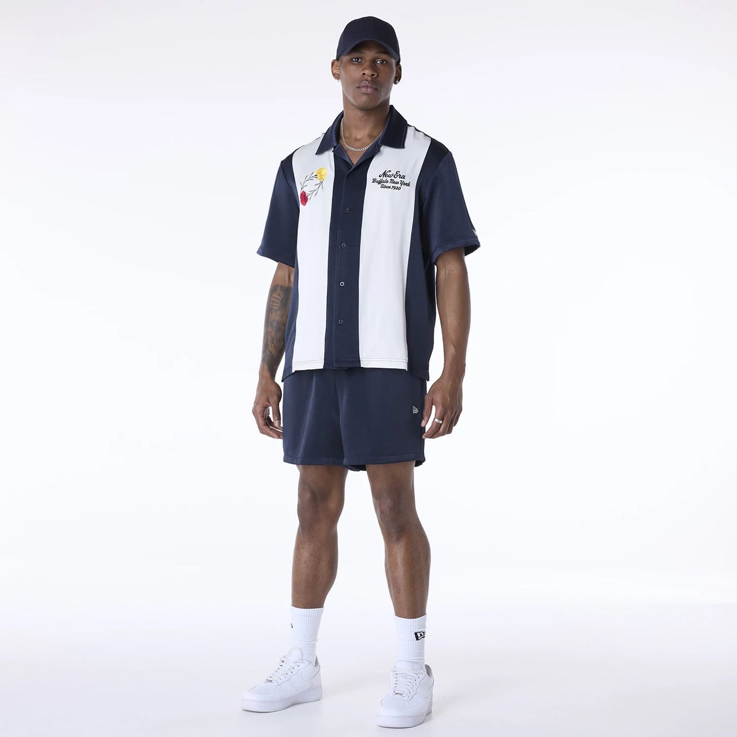 The Male model is wearing New Era Stripe Revere Navy Short Sleeve Shirt 4