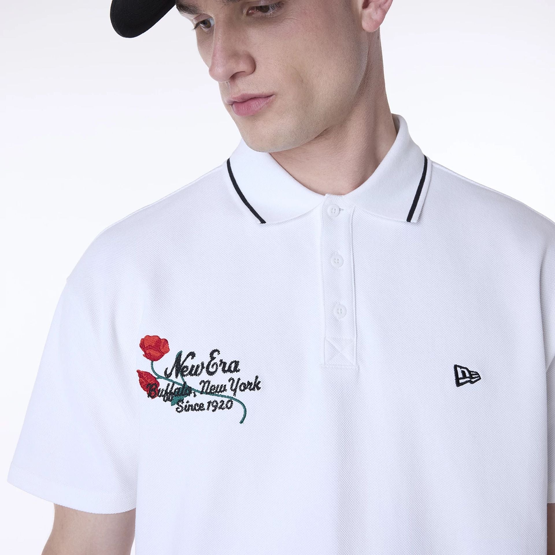 The Male model is wearing New Era Floral Polo White T-Shirt 4