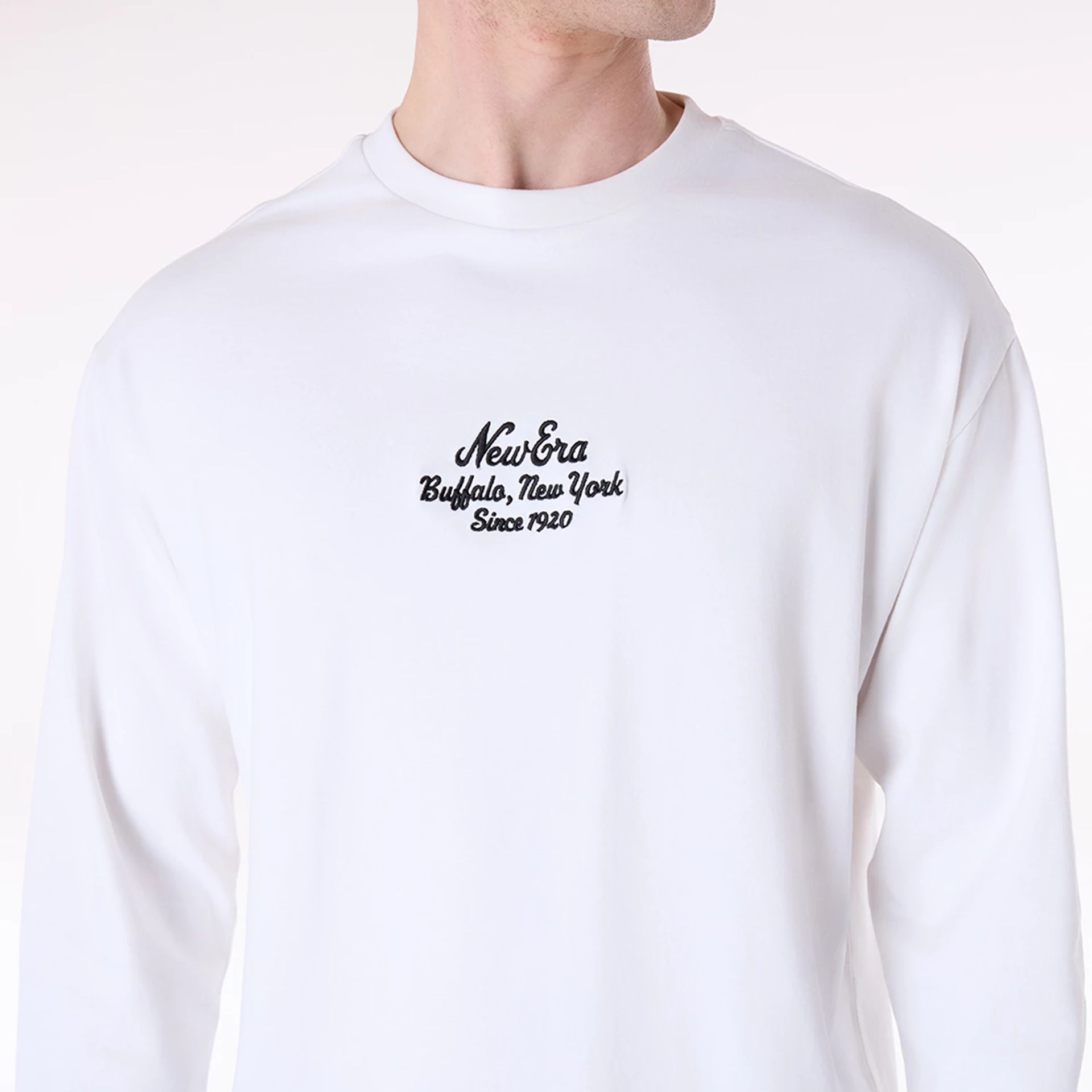 The Male model is wearing New Era Graphic White Long Sleeve T-Shirt 6