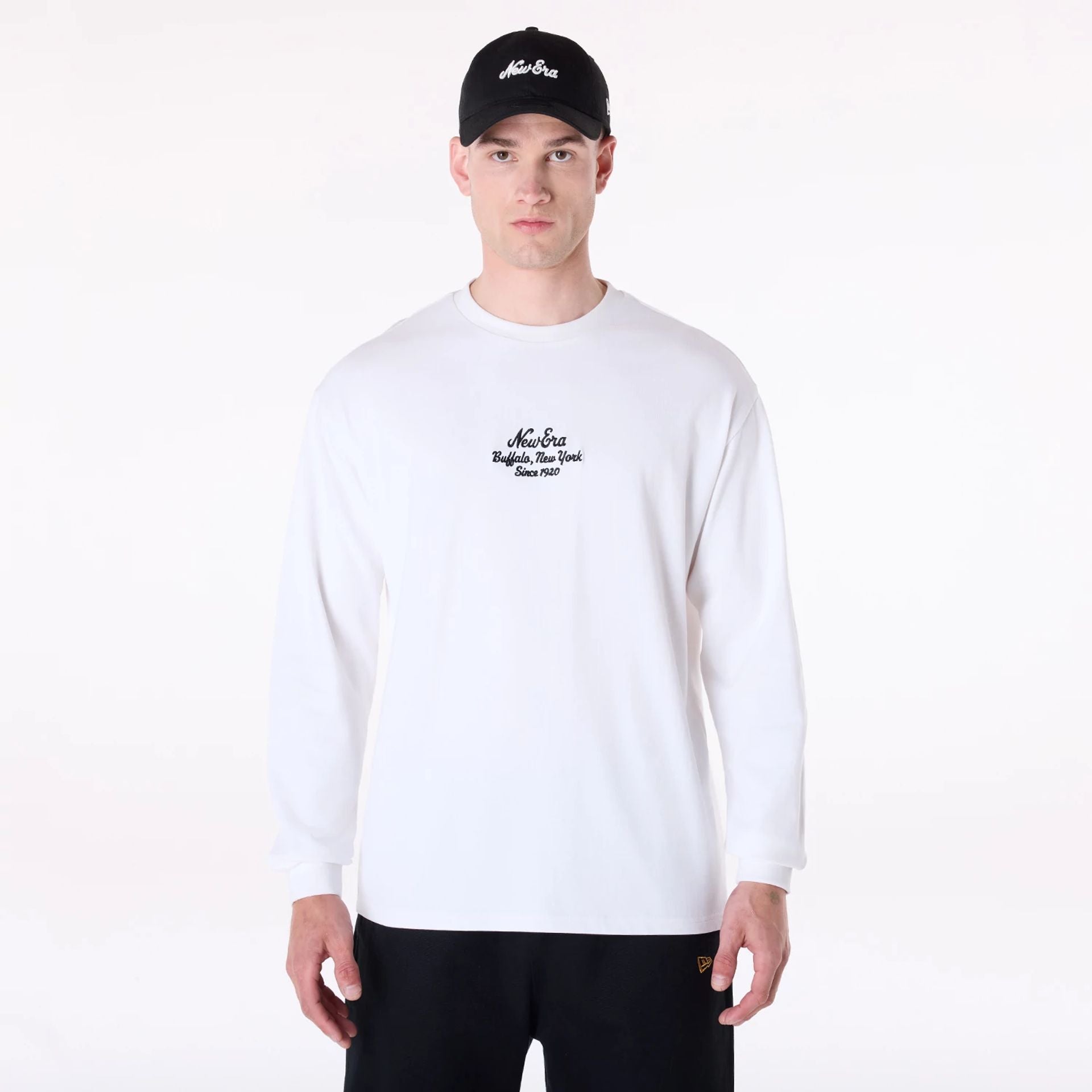 The Male model is wearing New Era Graphic White Long Sleeve T-Shirt 1